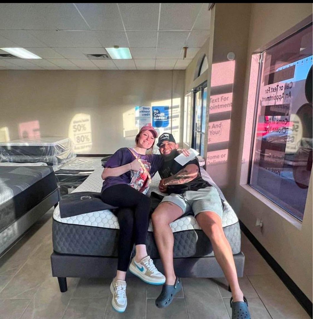 Couple shopping for mattresses