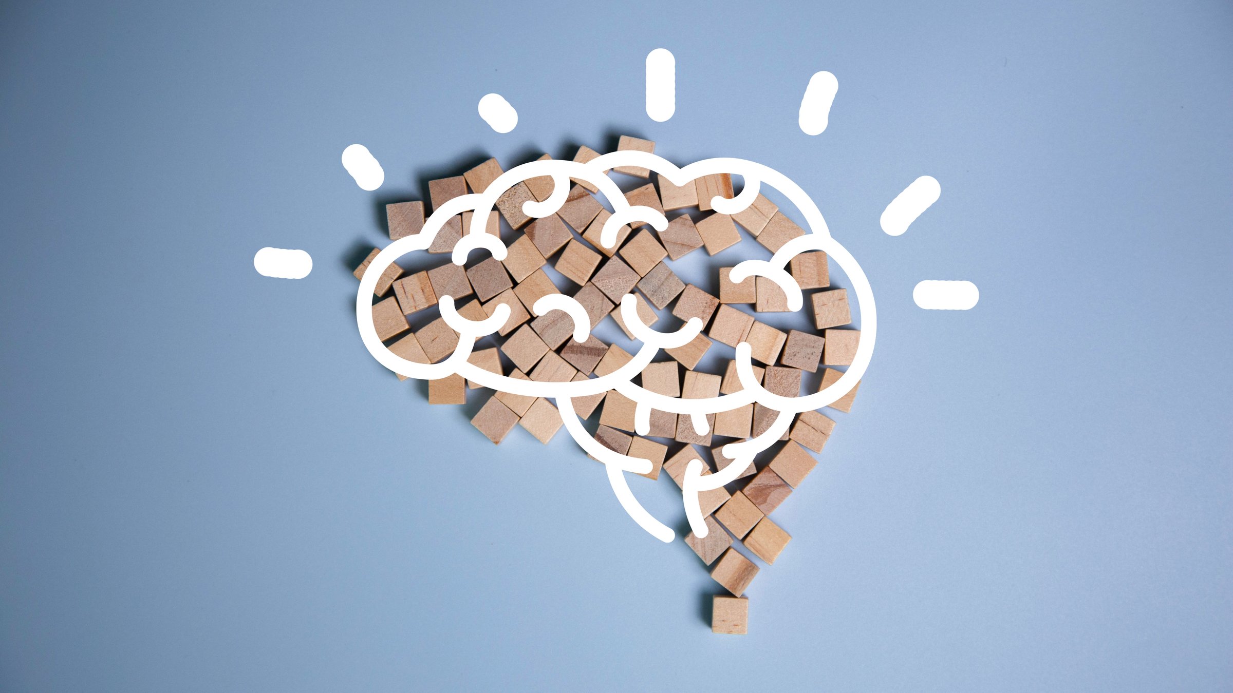 Brain icon on wooden blocks arranged in the shape of a brain on a blue background in top view. Brain Nervous System concept. human brain, thinking concept. Concept of creativity and intelligence