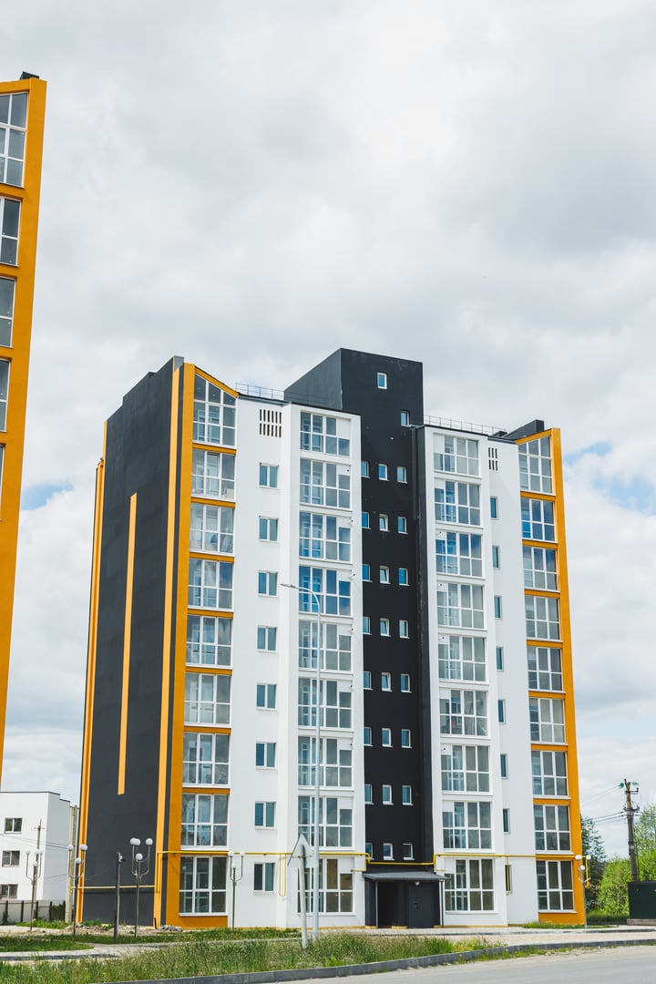 New modern multi-storey residential building. Plastic windows in a new apartment. Apartment with a balcony.