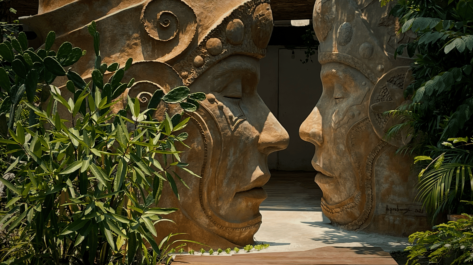 Two large stone sculptures of faces with tribal motifs, facing each other in a lush garden setting.