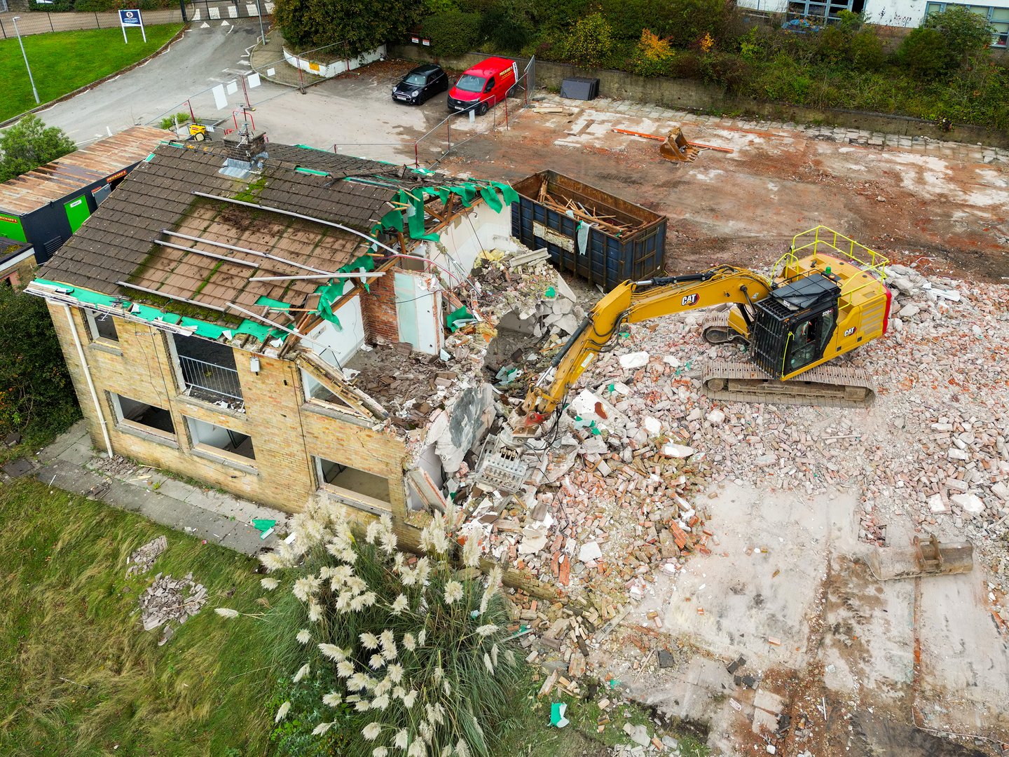 Church Village, Pontypridd, Rhondda Cynon Taf, Wales, UK - 30 October 2024: Excavator demolishing an old people's residential care home to make way for a new development