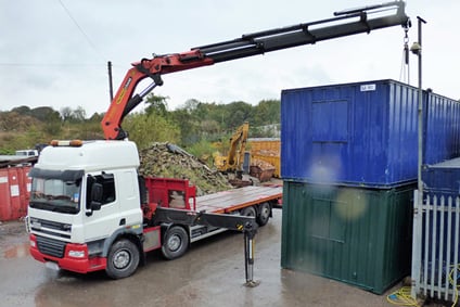 HIAB crane truck with mobile crane lifting shipping container