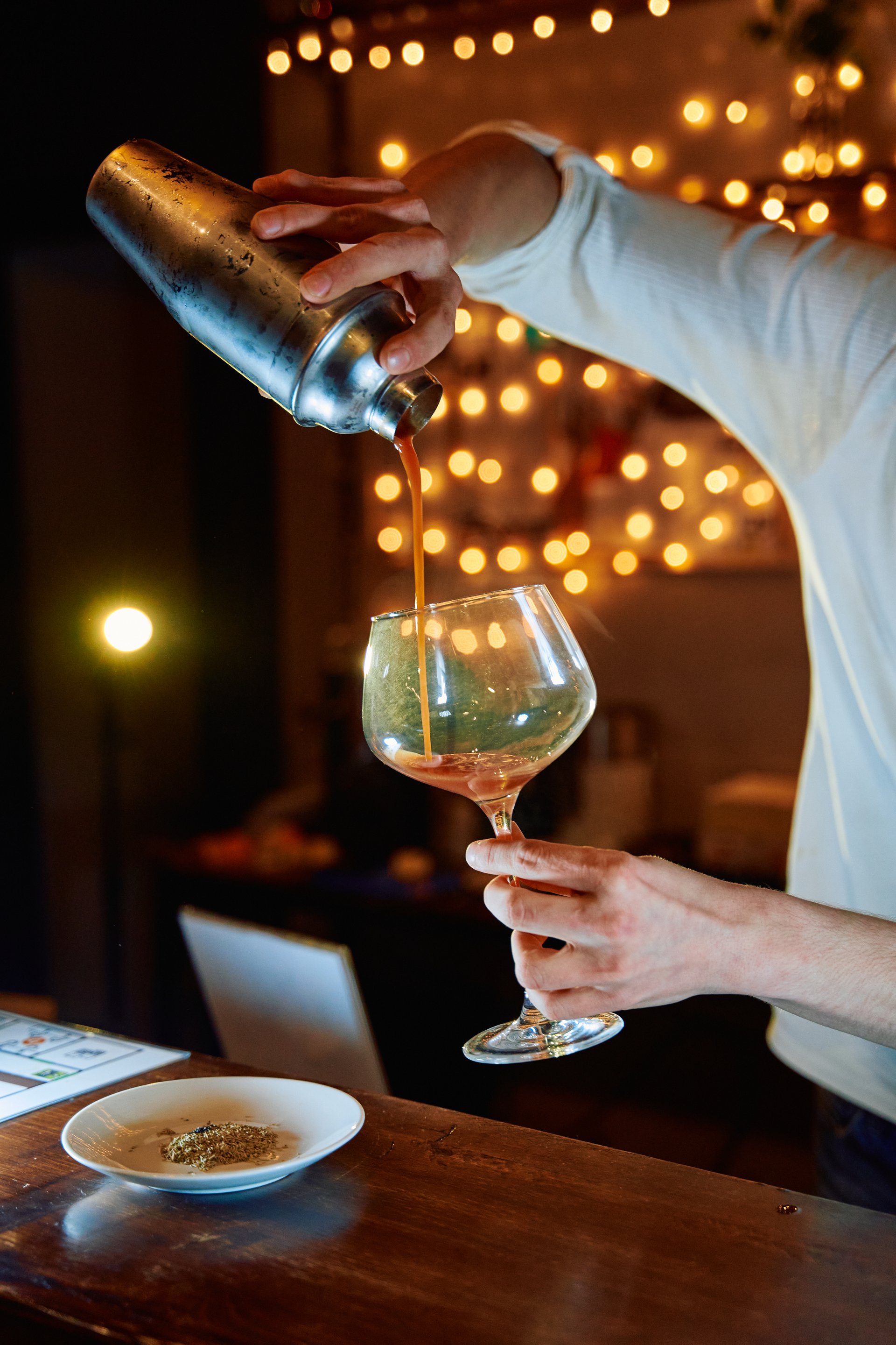 Bartender skillfully pouring a cocktail in an elegant bar setting