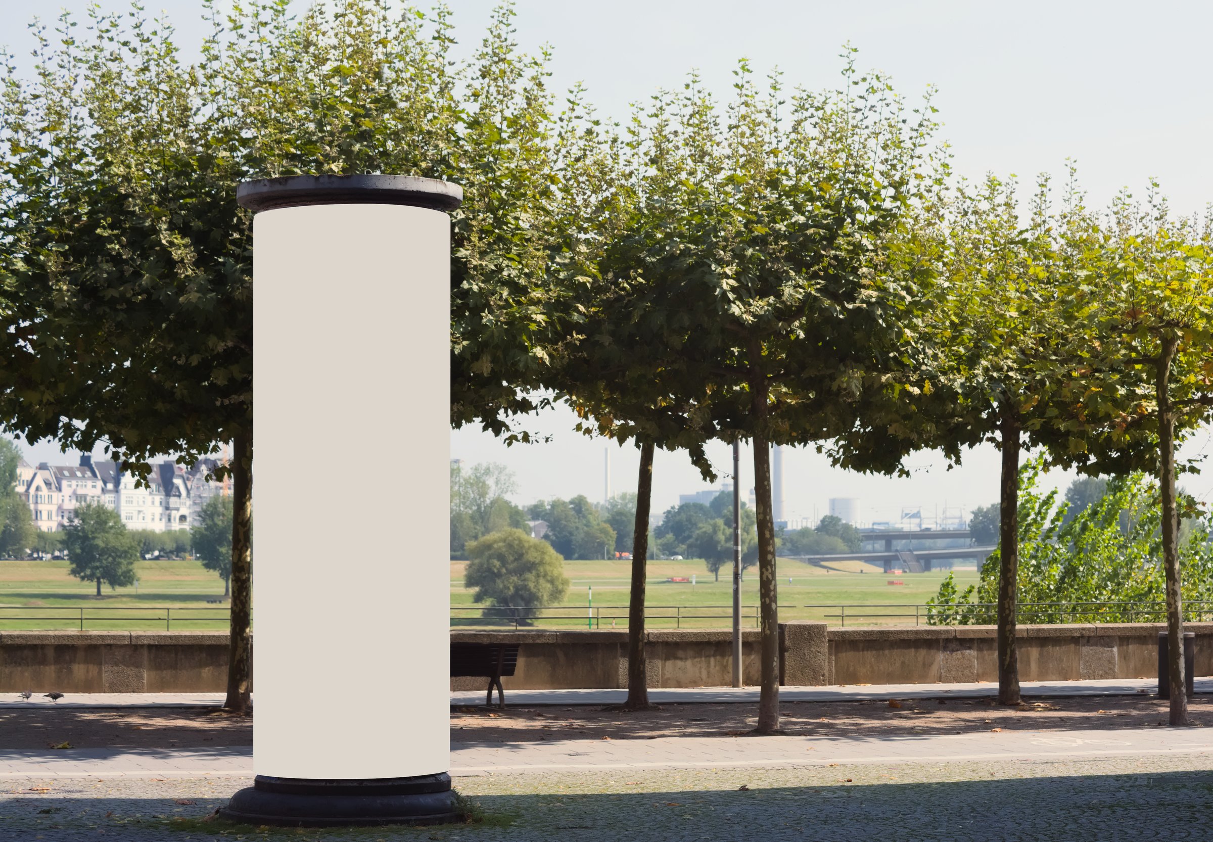 Empty advertising pillar in a city with grey  free copy space, promotion mock up. Blank advertising panel
