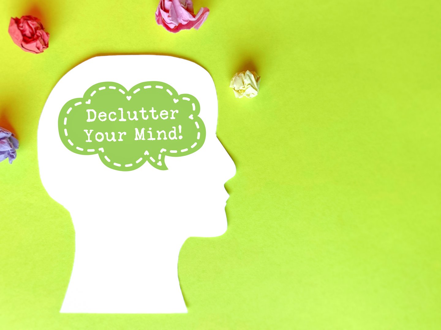 Declutter your mind text with speech bubble on head and crumpled paper ball background. For clean, clear and improved memory concept.