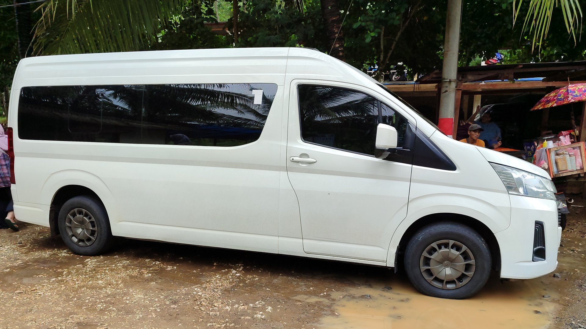 A white Toyota Hiace Premio in the parking spot