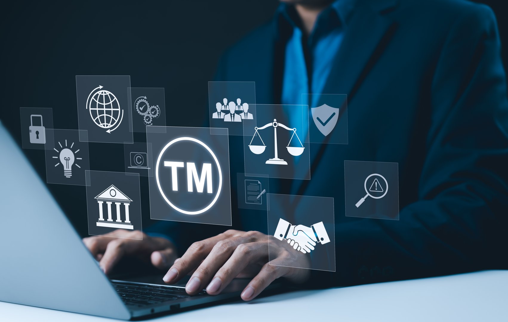 TM, Trademark and intellectual property protection concept. Businessman working on laptop with virtual icons representing trademarks, intellectual property rights, legal scales, security, innovation,