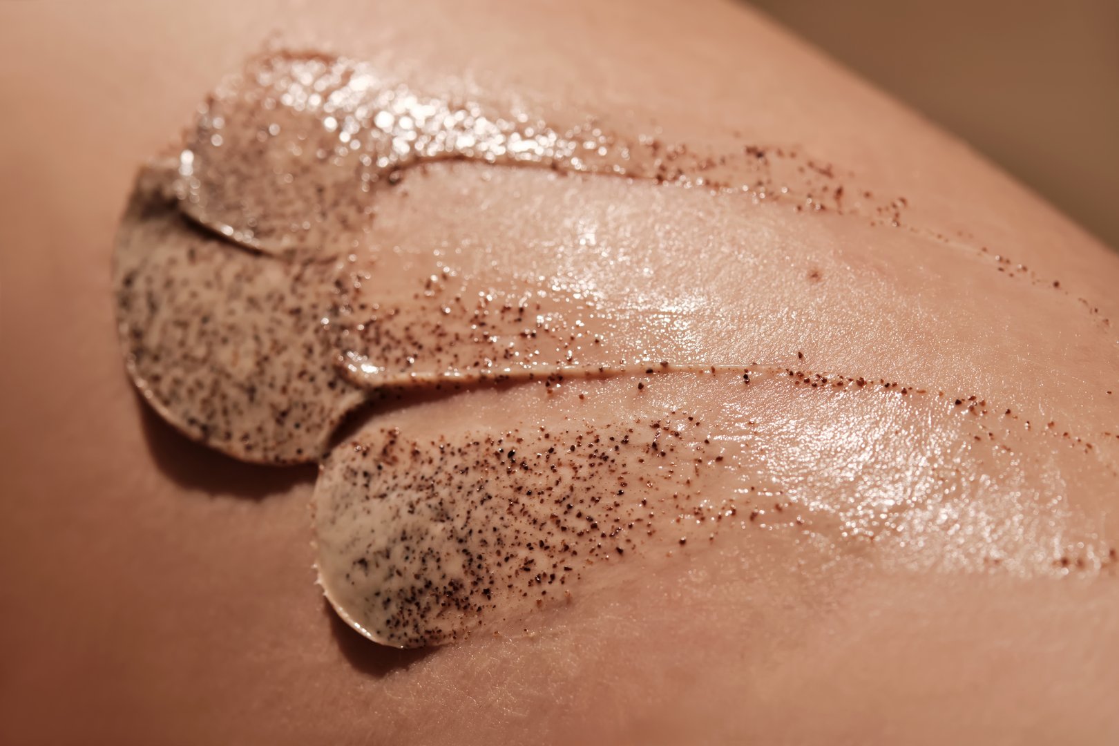 Coffee cream scrub on human skin close-up. High quality photo