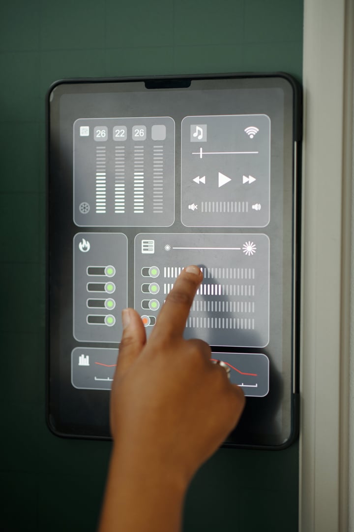 Close-up of hand operating digital interface of smart home control panel Adjusting various settings such as volume, light brightness, and connectivity functions