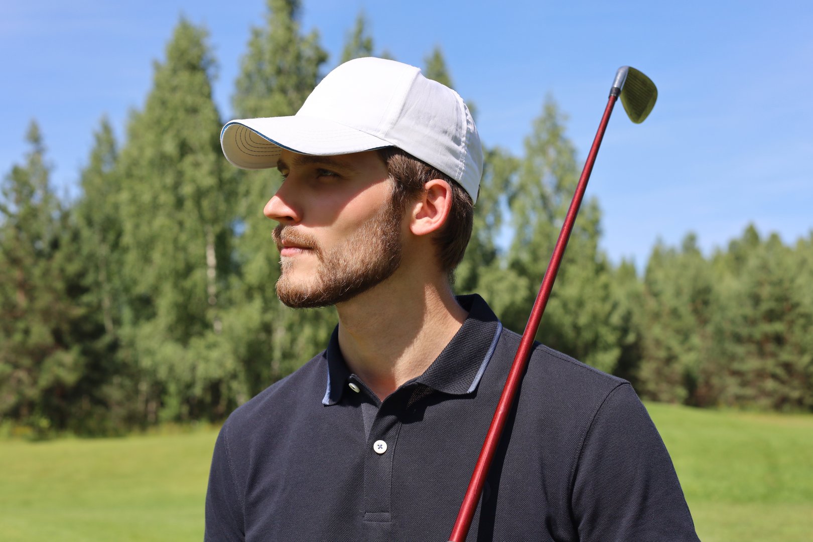 Man playing golf on beautiful sunny green golf course