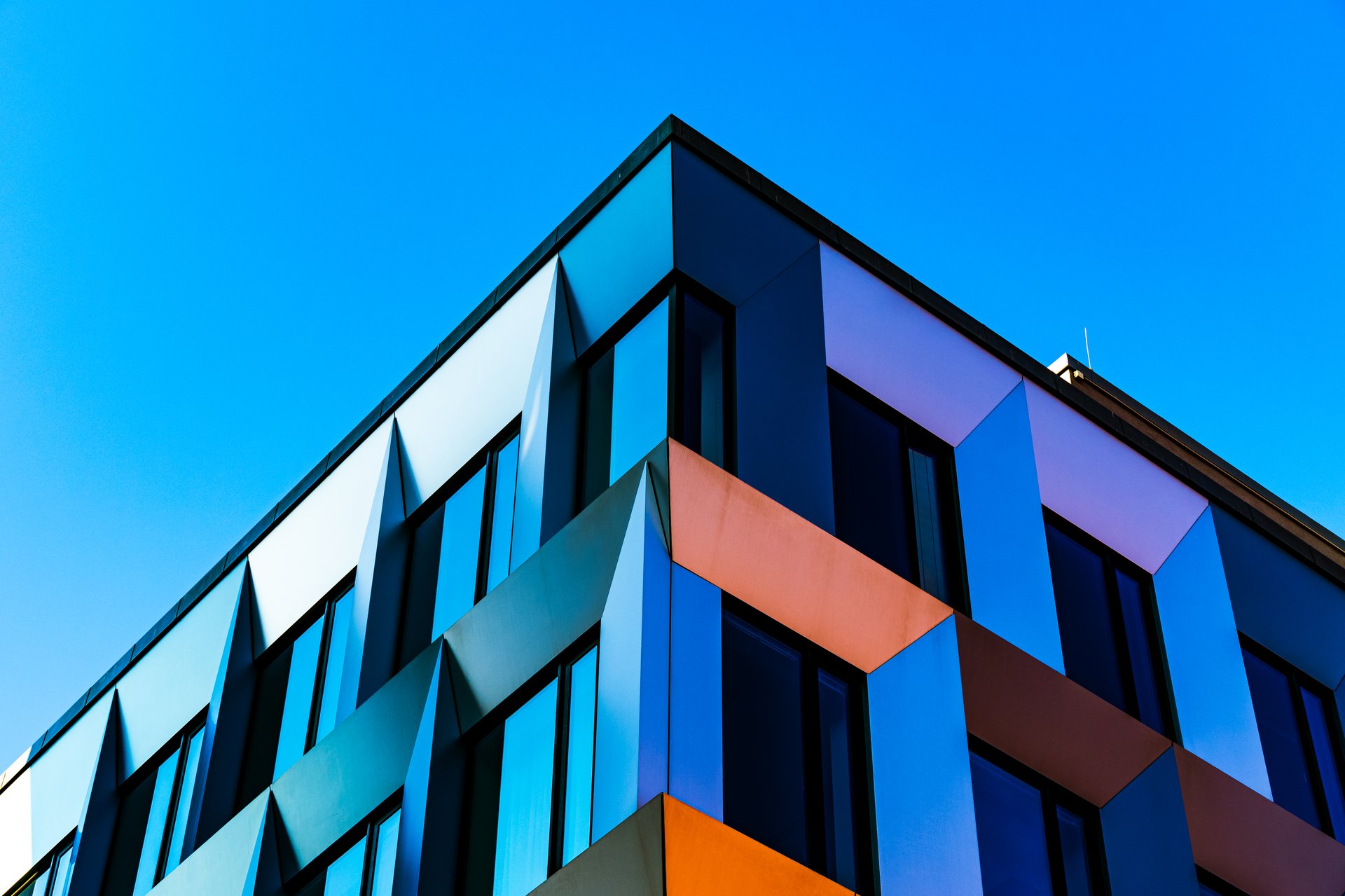Abstract Colorful Architectural Facade with Interplay of Light, Shadows, and Angular Geometric Patterns