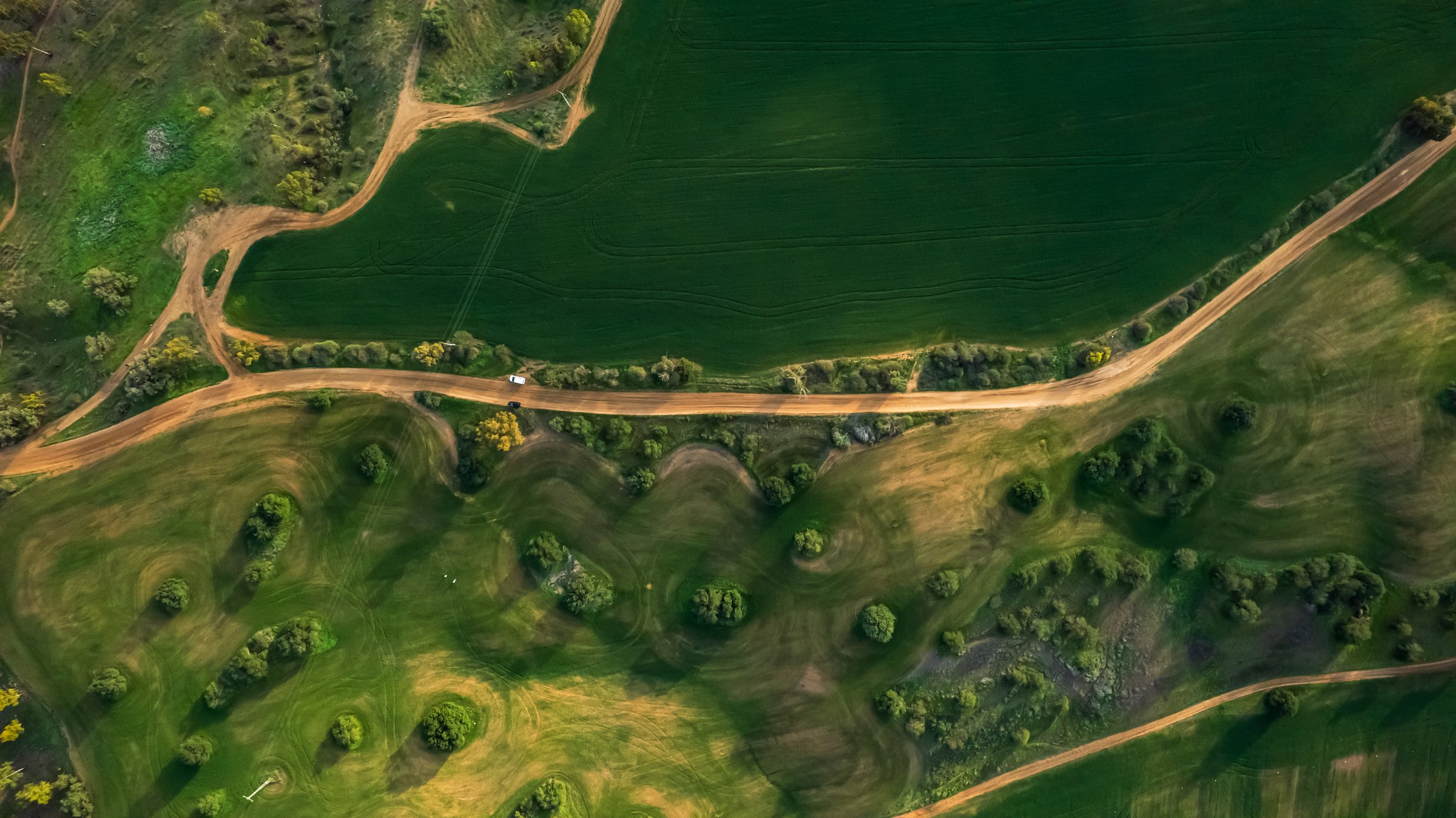 Shot Of Agricultural Field On Sunny Day, Drone Flying Over Landscape Against Sky - Ruhama Badlands, Israel
