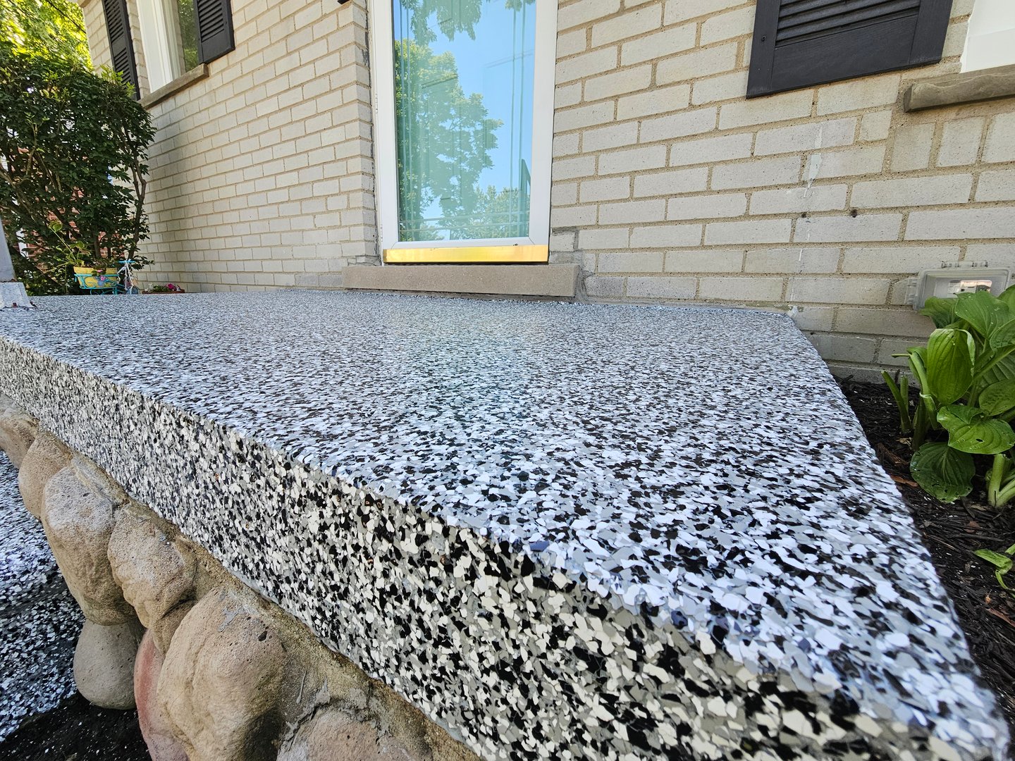 A polyaspartic uv protected front porch flake system