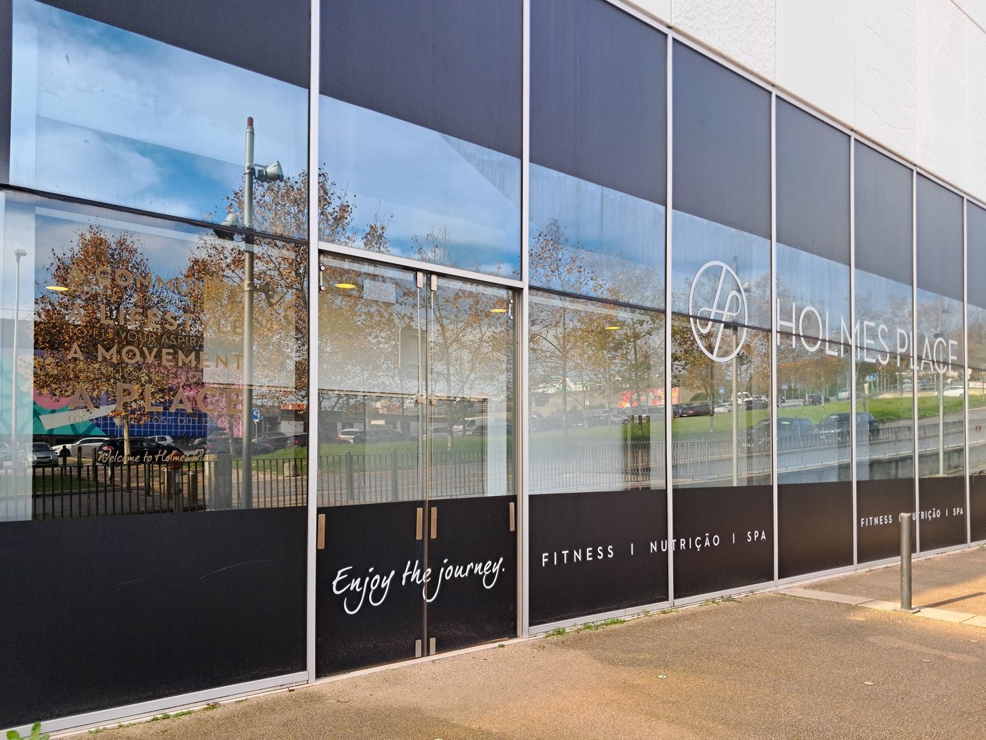 Lisbon, Portugal, December 14, 2024, Modern glass facade of holmes place fitness center in lisbon, portugal, promoting health and wellness