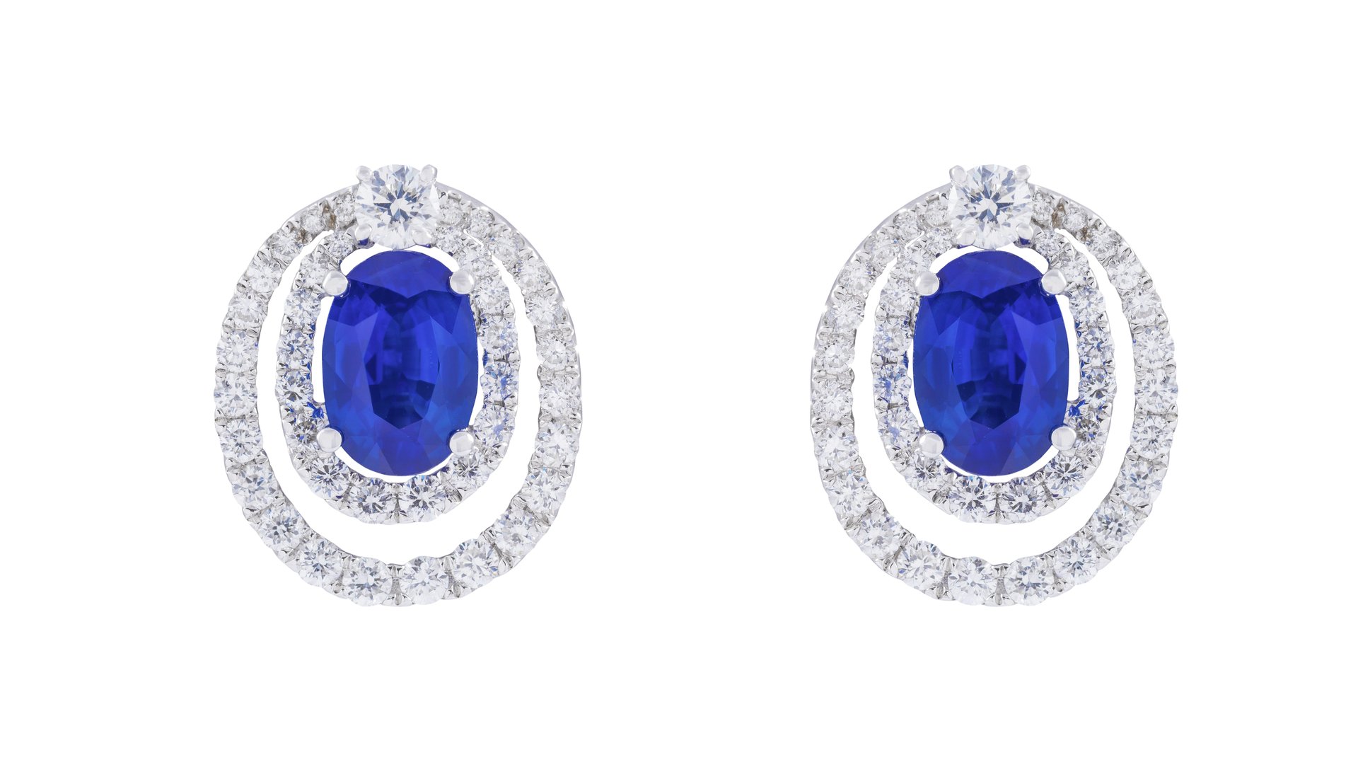 A close-up of elegant sapphire and diamond earrings, showcasing their intricate design