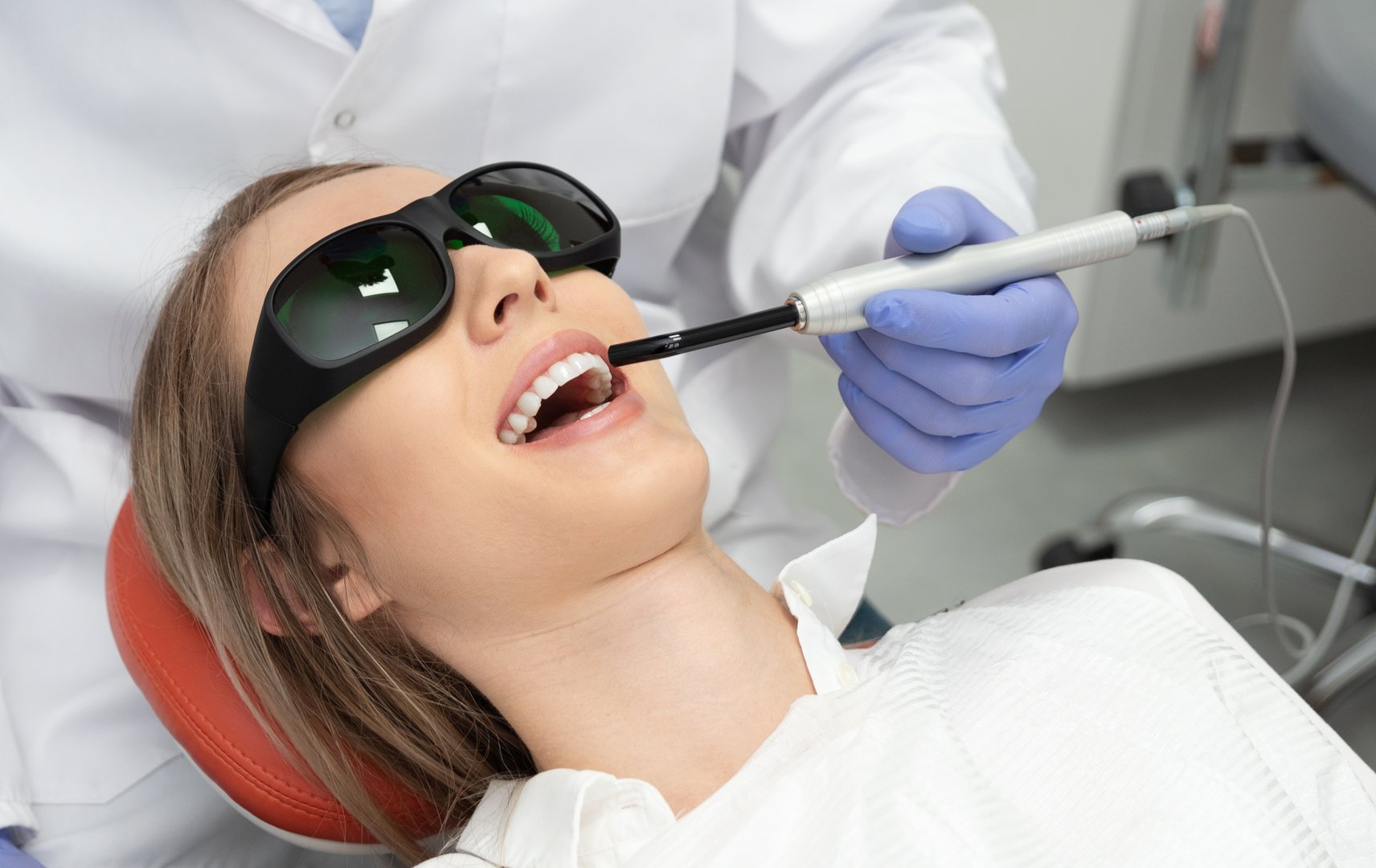Using a modern method of laser teeth treatment. Dental care, perfect smile