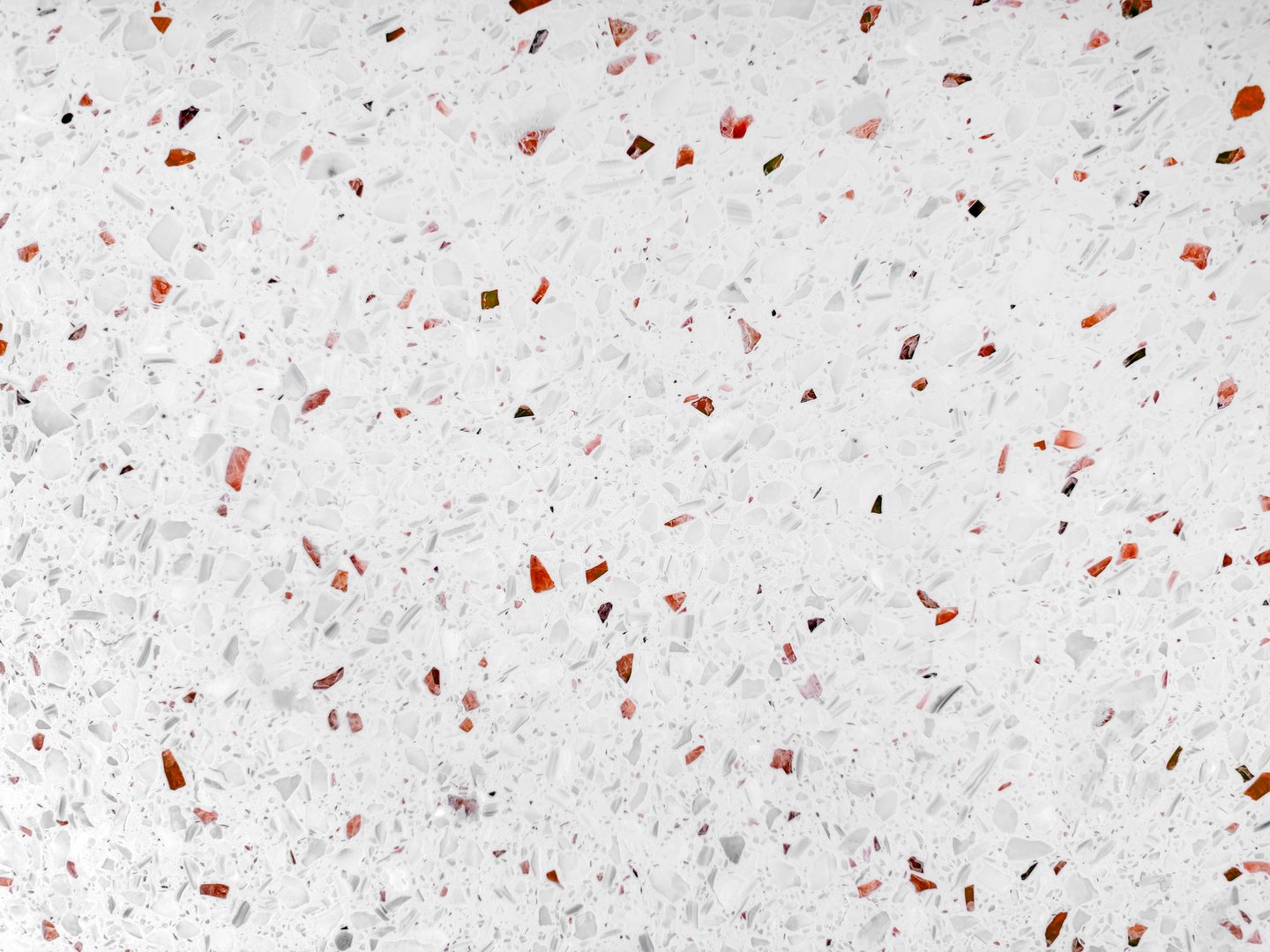 Bianco ruby red Terrazzo surface, characterized by a predominantly white base speckled with numerous irregular chips and fragments of red glass. modern terrazzo background.