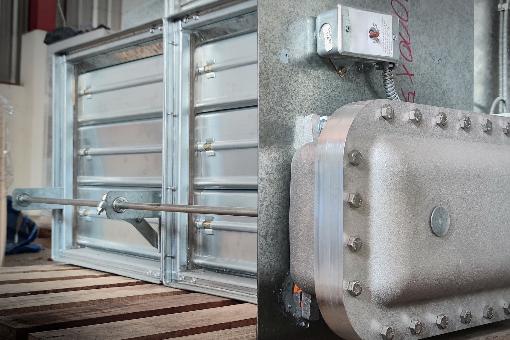 An explosion-proof motorized fire damper close up shot.