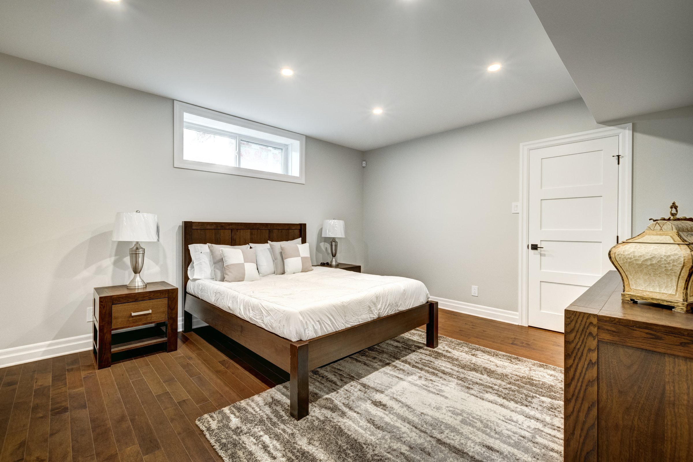 Modern finished basement bedroom with egress window