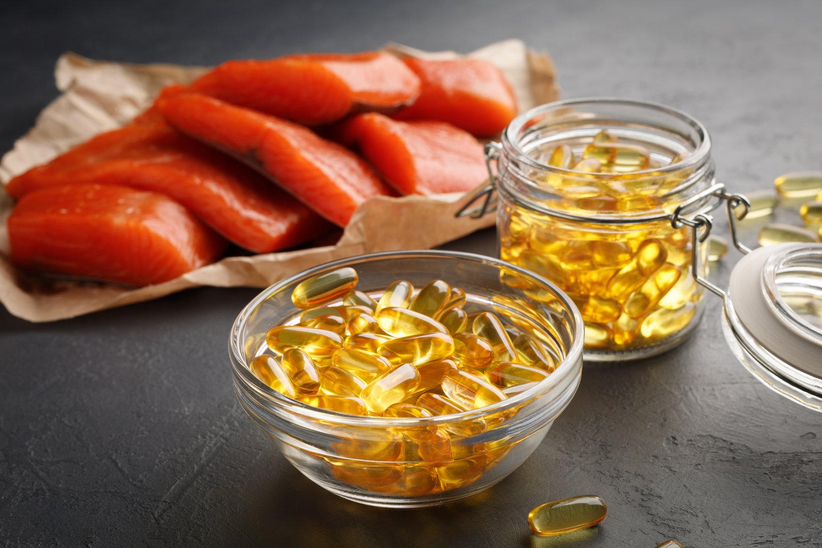 Vitamin D supplement concept - omega 3 capsules and salmon red fish