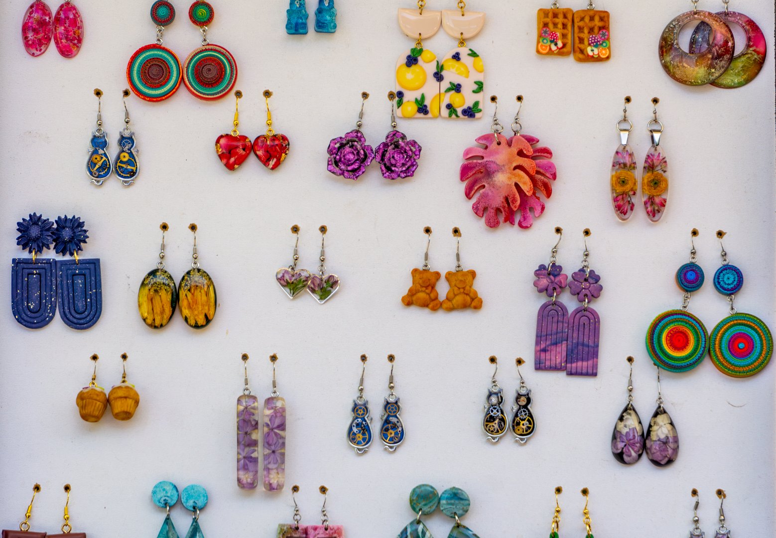 Colorful handmade earrings at craft market