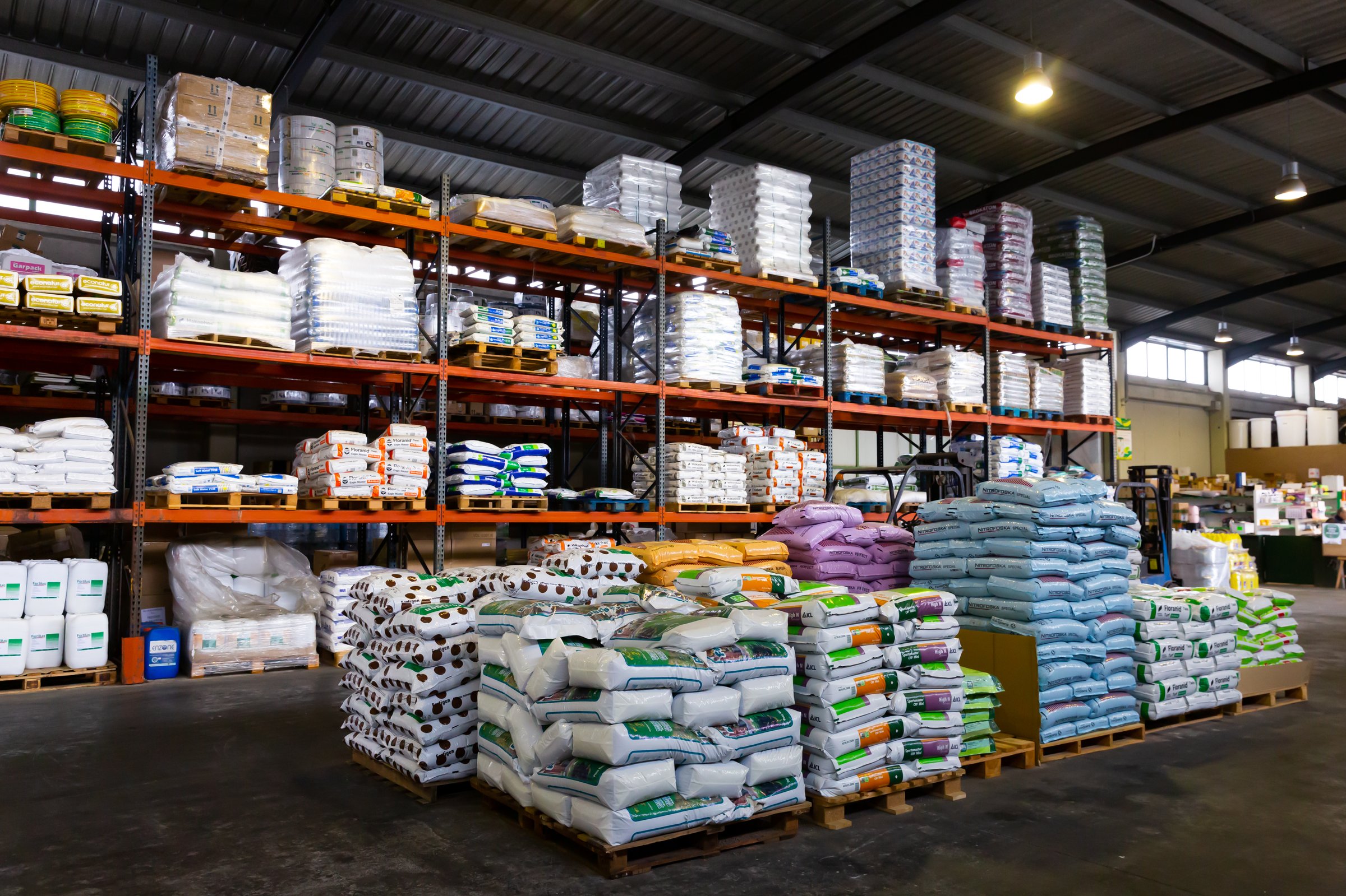 Various fertilizers in plastic sacks on pallets in large garden center of Barcelona