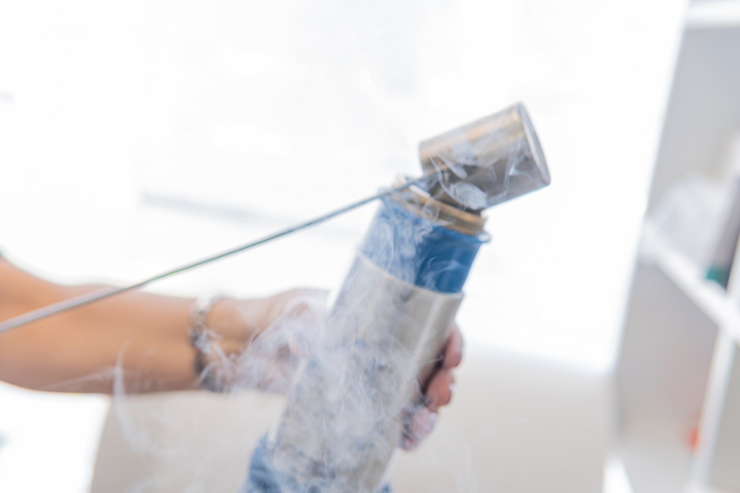 Selective focus of a hand with container with nitrogen placing in a cryotherapy gun
