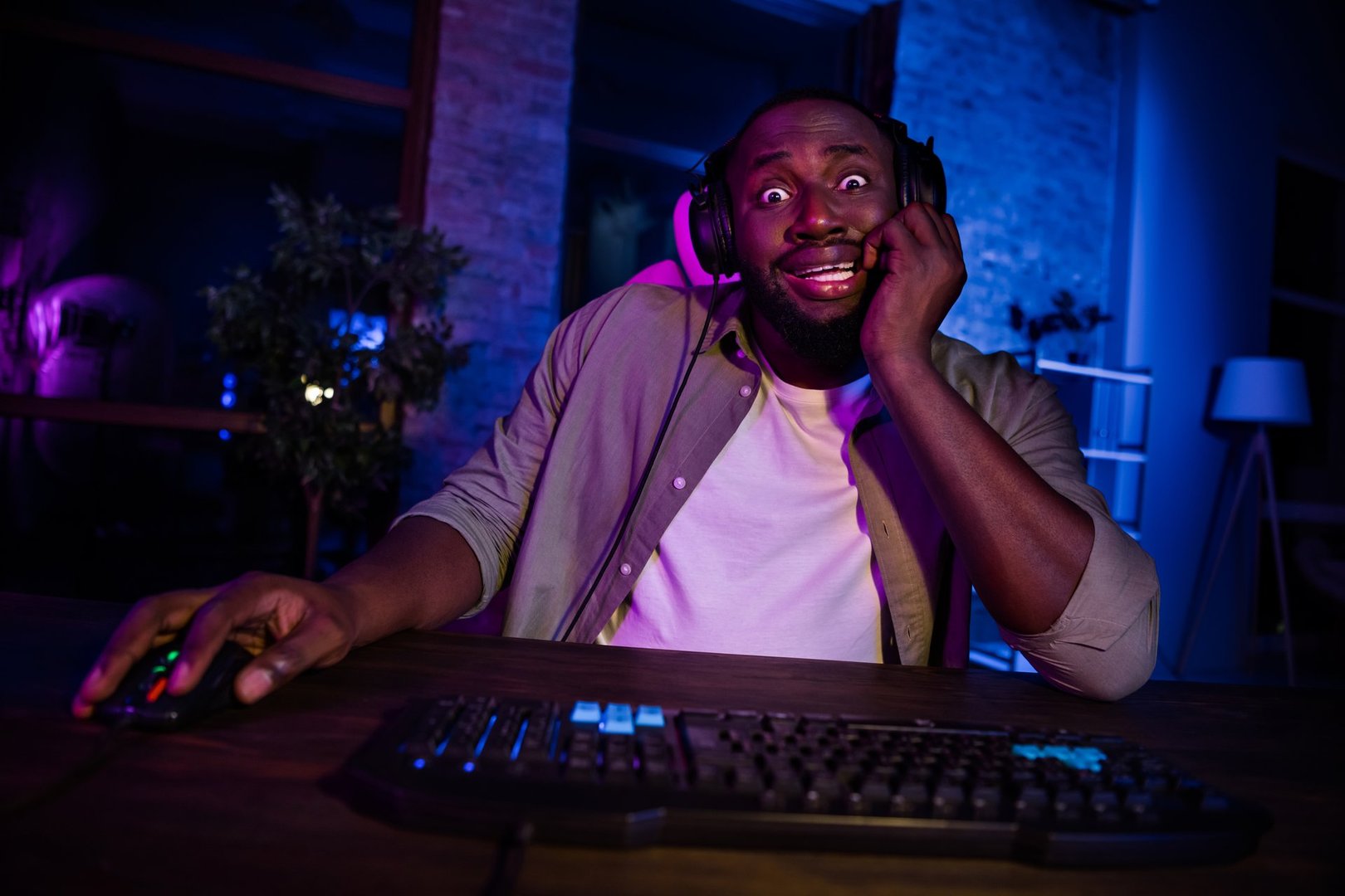 Photo of amazed horrified young man sitting chair biting finger mails staring late night house.