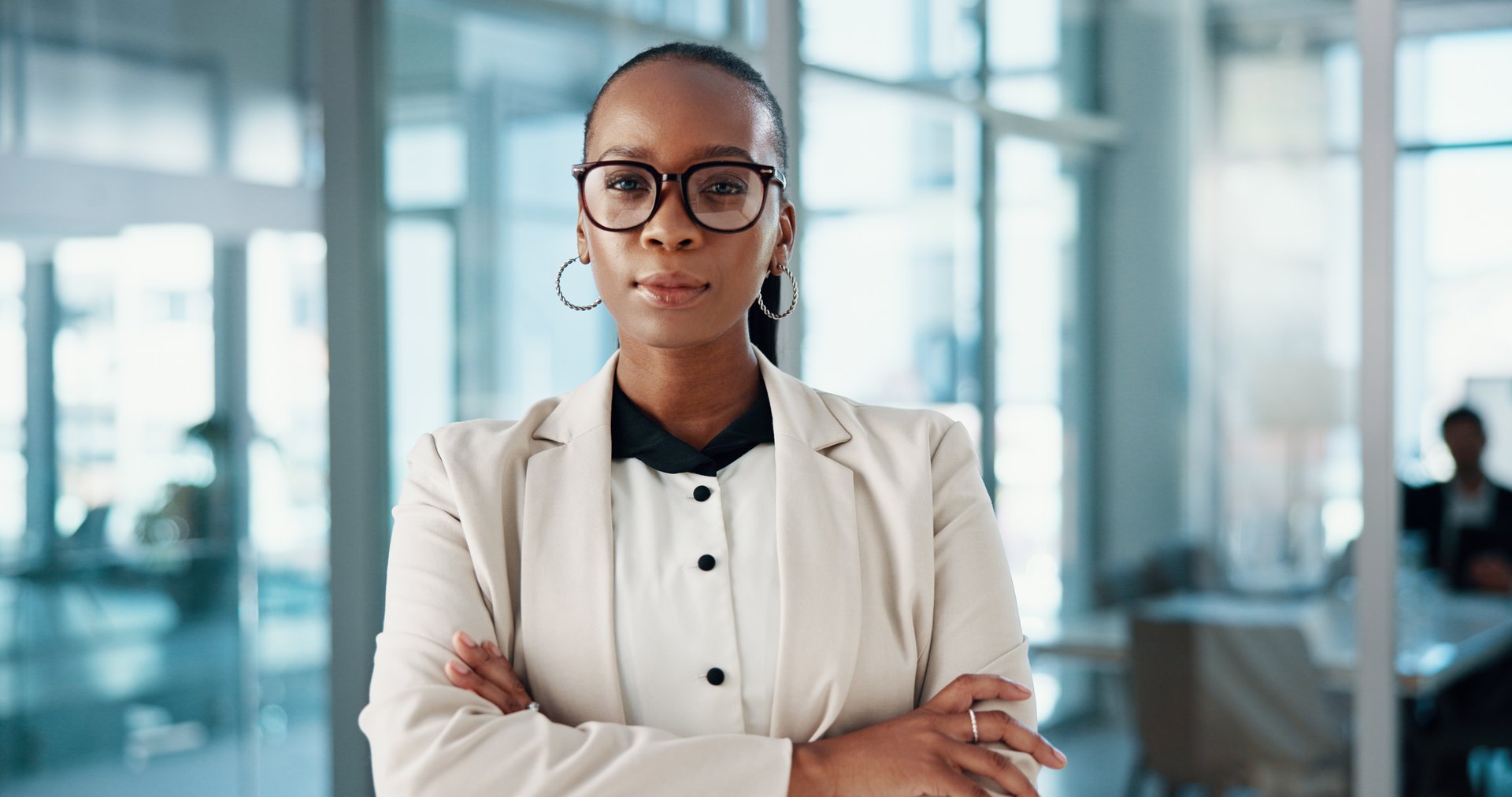 Crossed arms, pride and portrait of black woman in office with corporate finance career. Serious, professional and African female financial account executive with confidence for business development.