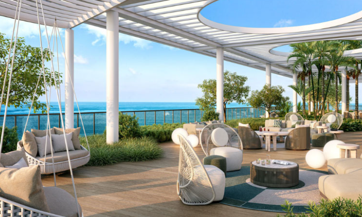 Modern rooftop terrace with ocean view, stylish seating, plants, and a pergola providing shade.