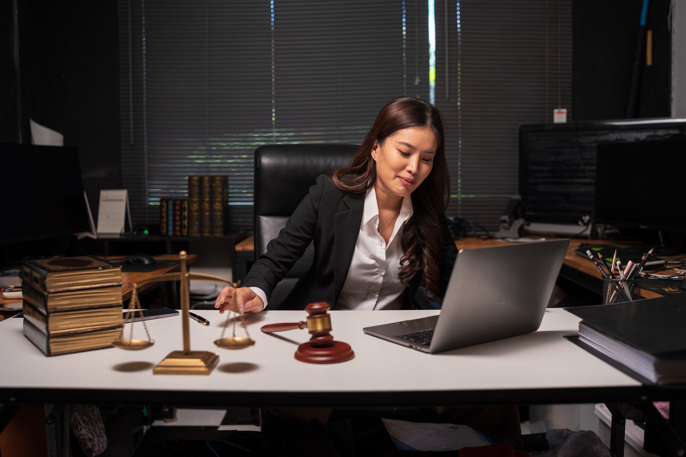 Female lawyer is working on legal documents in an office.