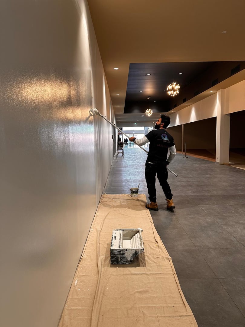 Professional painters working on commercial interior painting project