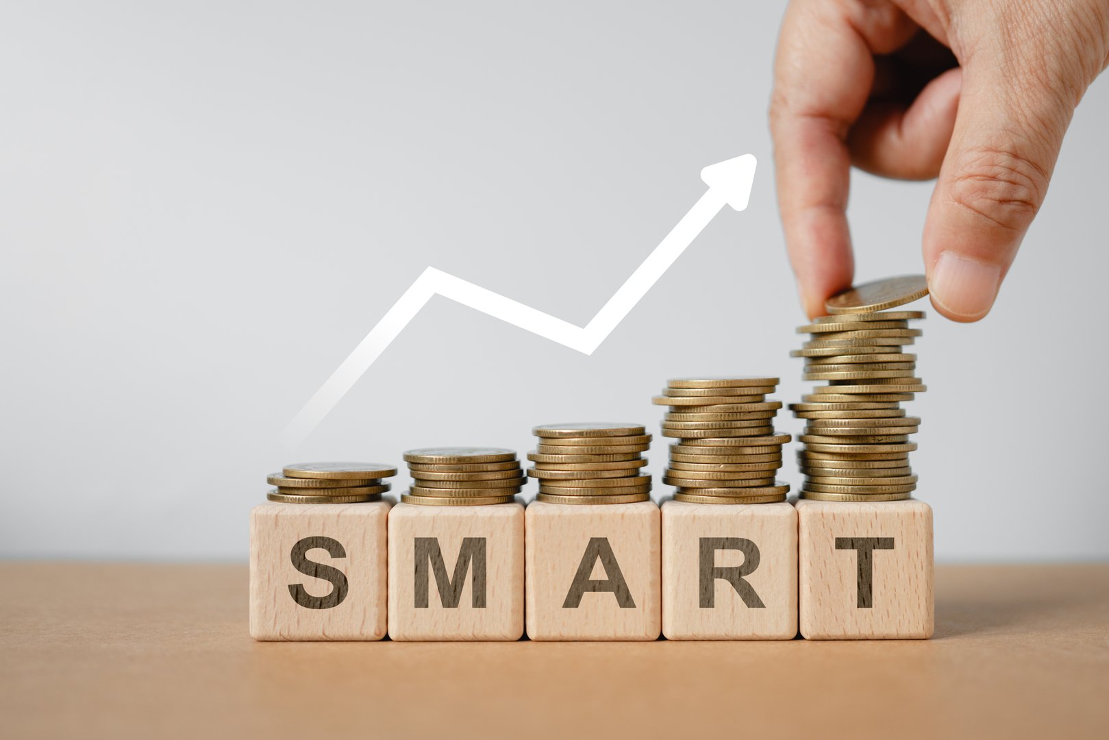 For smart idea to make money, spend wisely for more savings, smart investment business, specific, measurable achievable, realistic timely concept, Growth money stacks with text and hand