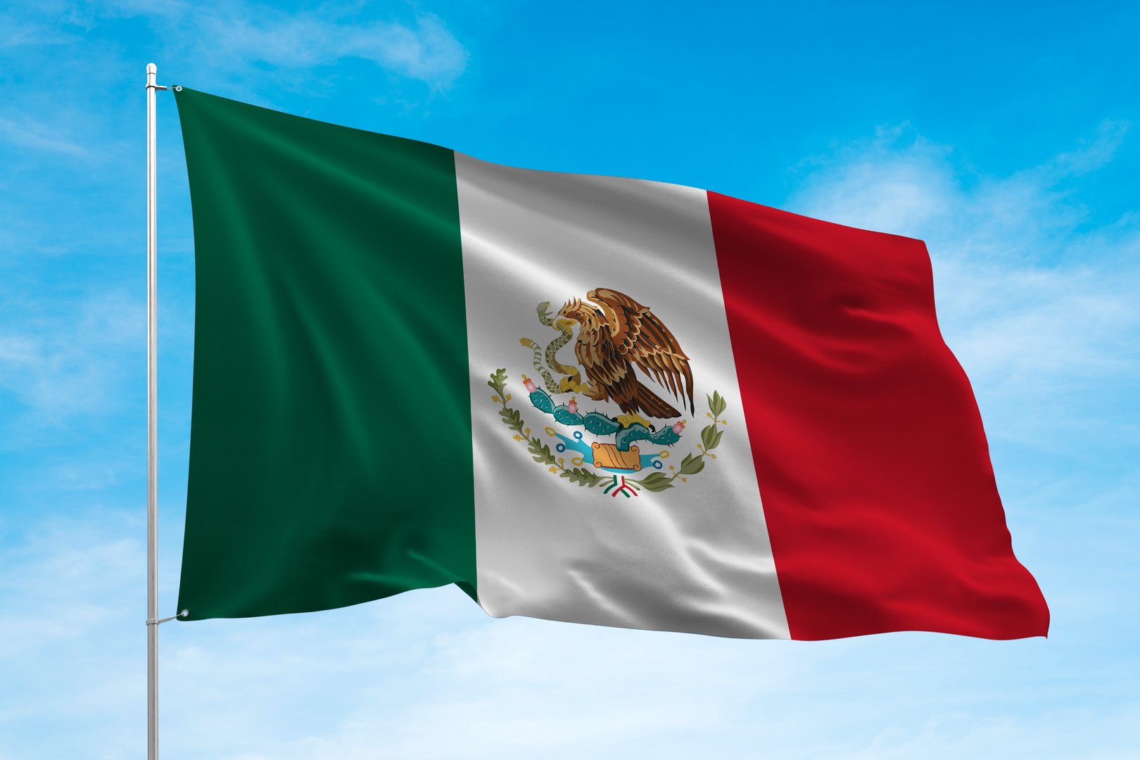 Mexico flag waving in the blue sky