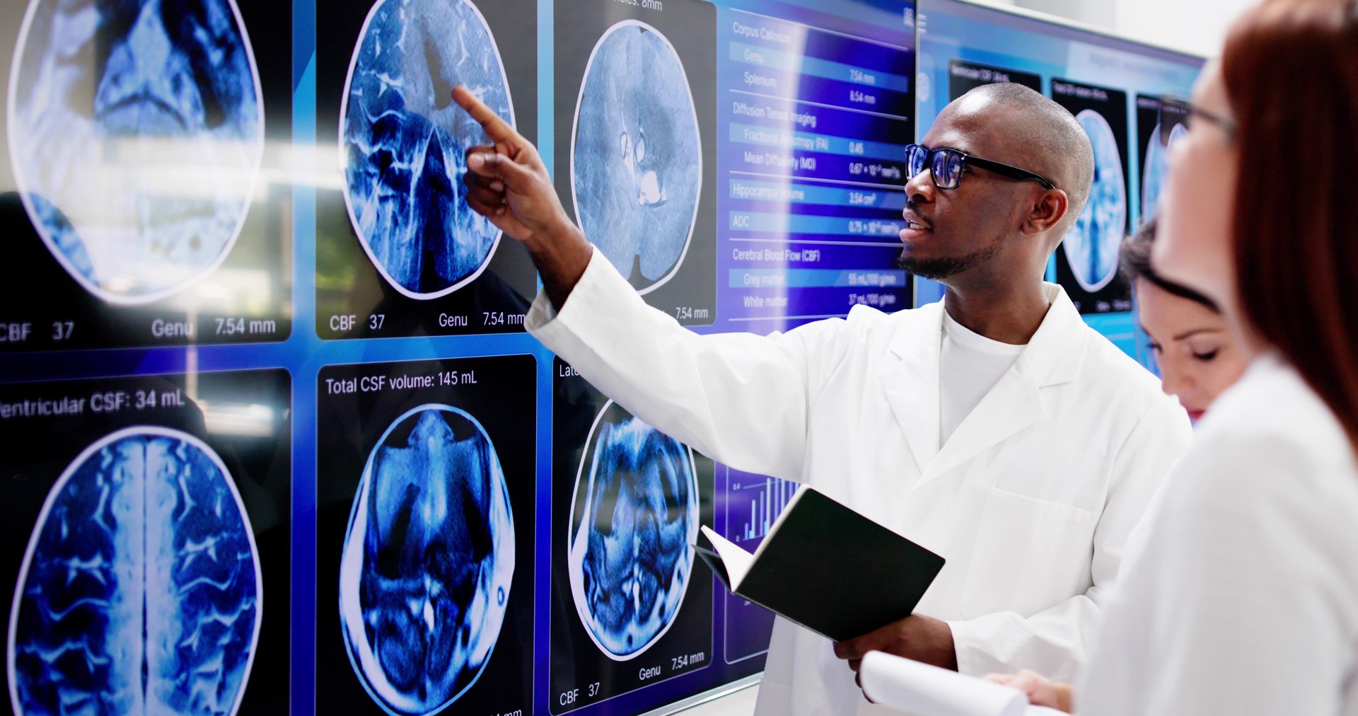 Doctors In Clinic Looking At Brain MRI Scan. Neurology Diagnosis