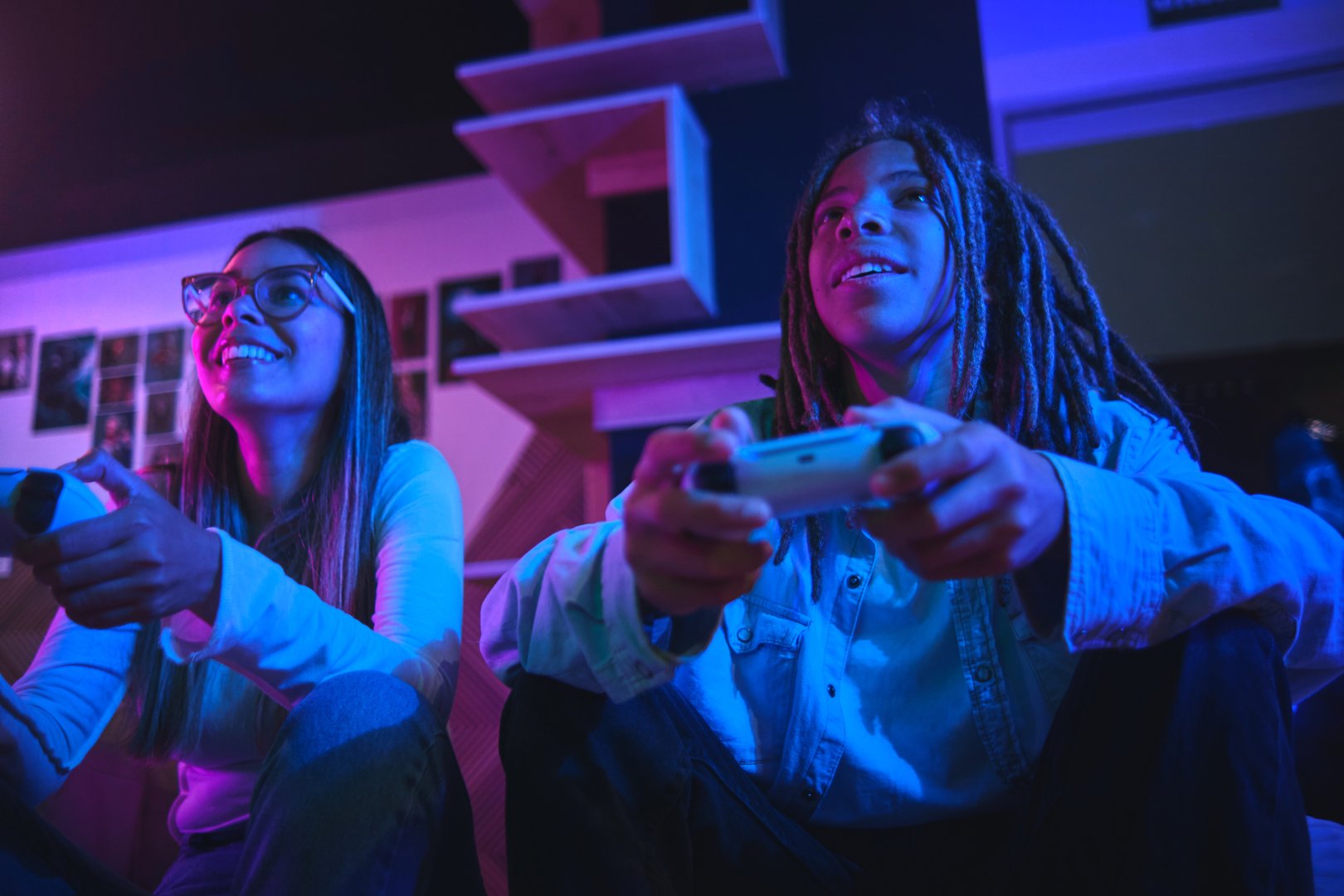 Influencer gamer couple playing games with joystick live streaming on social media in exciting neon atmosphere , technology concept, recreation