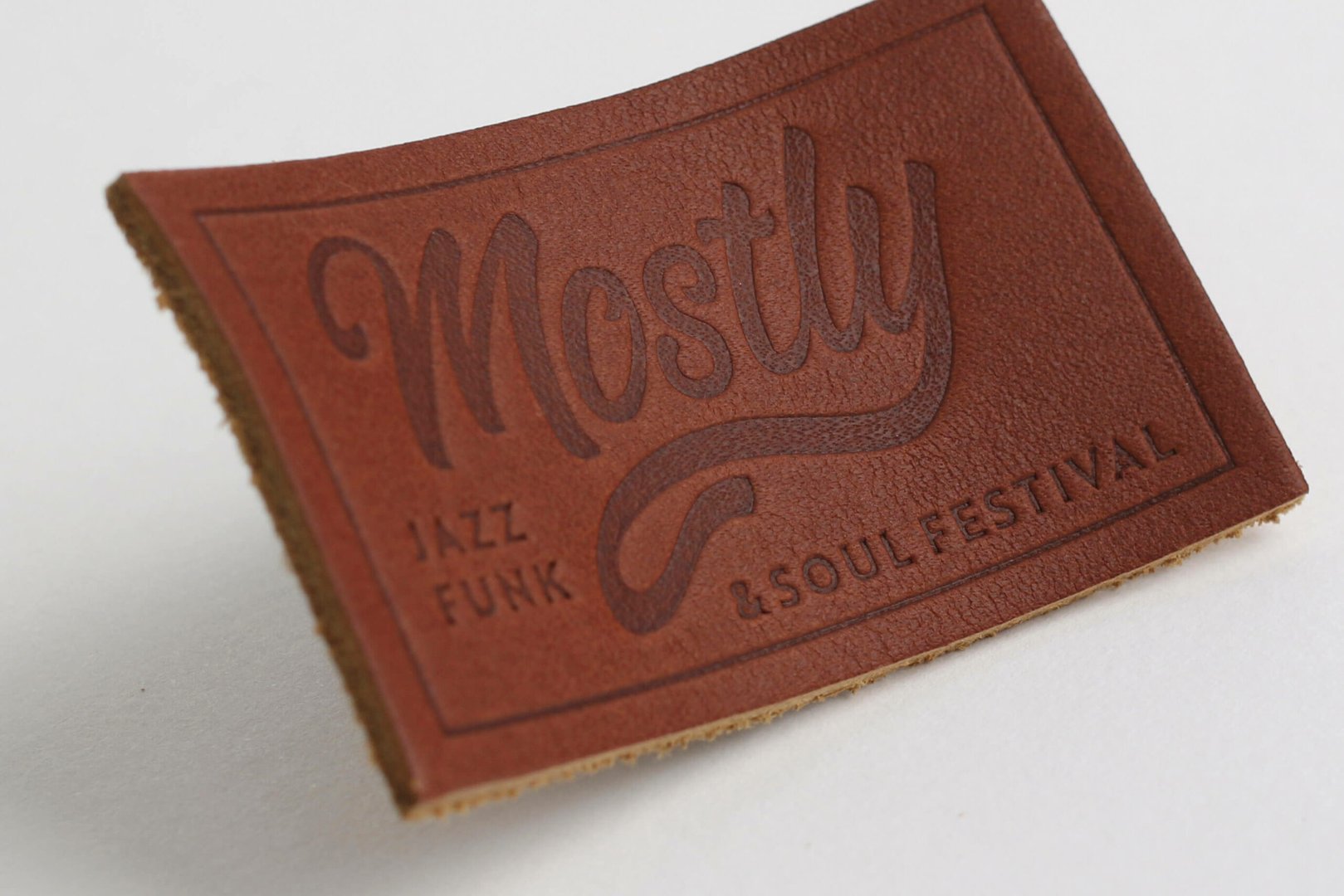 Rectangular leather patch embossed with Mostly Jazz Funk &amp; Soul Festival text on a white background.