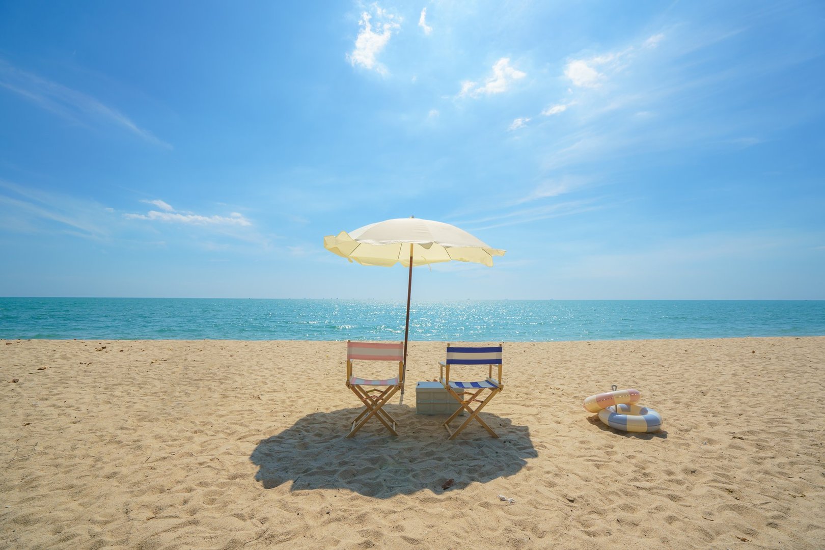 Chair and umbrella perfectly placed on a serene beach invites relaxation, capturing the essence of seaside serenity and the promise of a peaceful escape