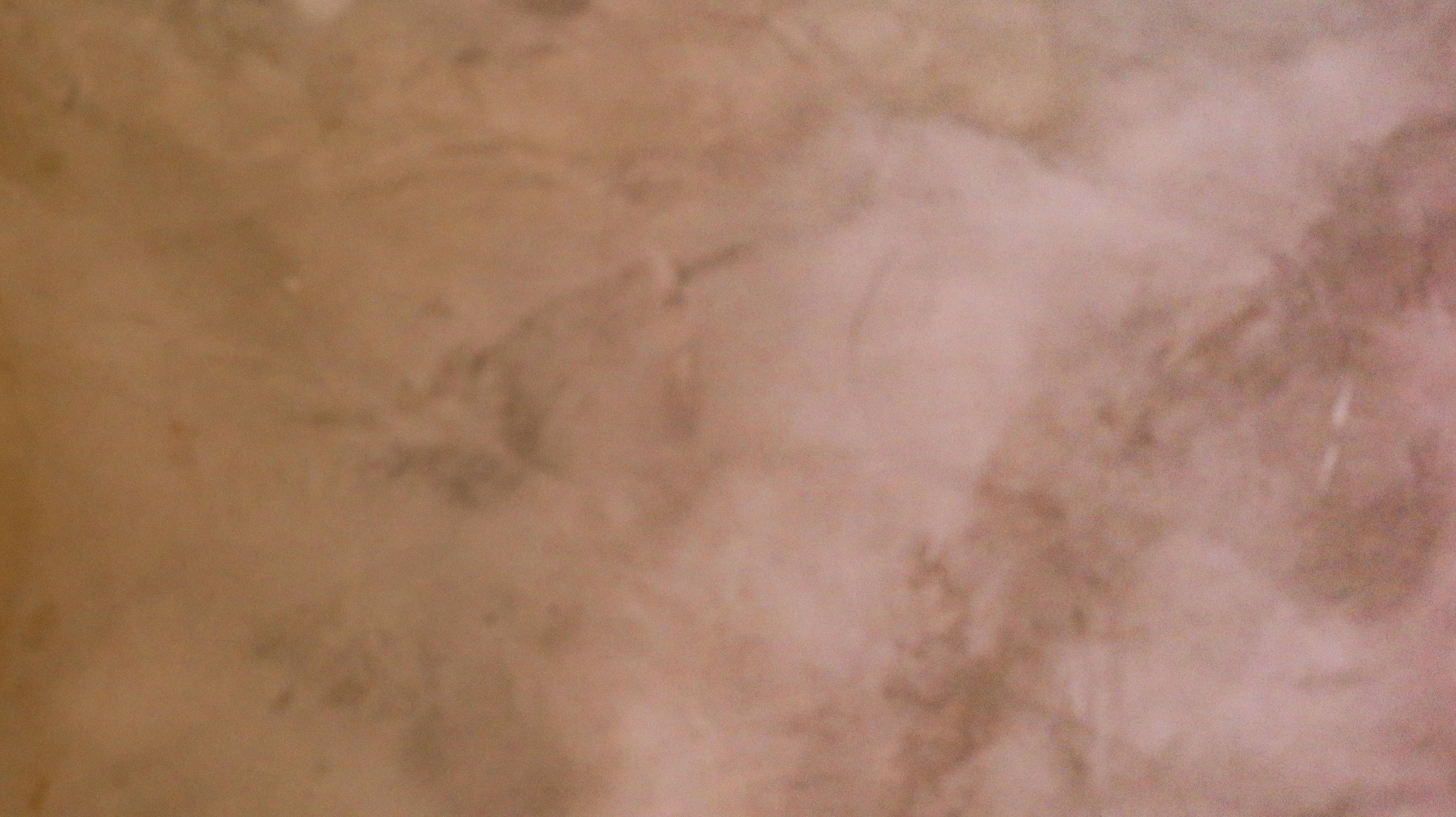 a close up view of an elegant textured marble wall surface with a subtle, warm beige tone.