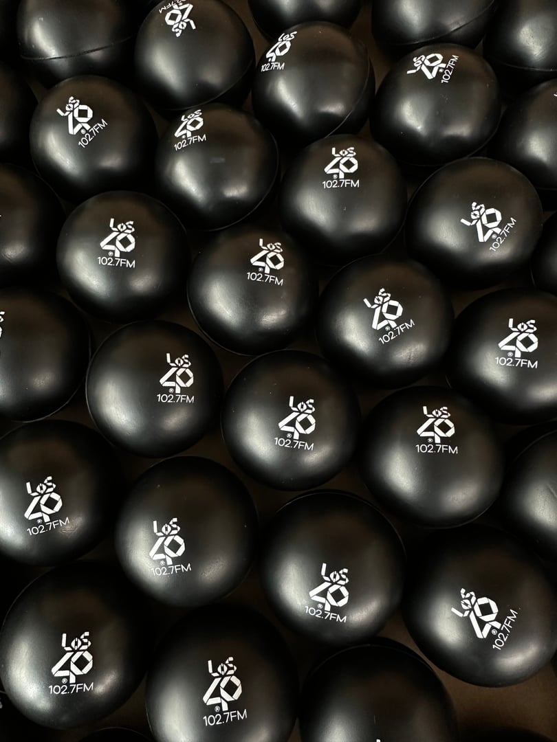 Black stress balls with "Los 40 102.7 FM" logo stacked closely together.