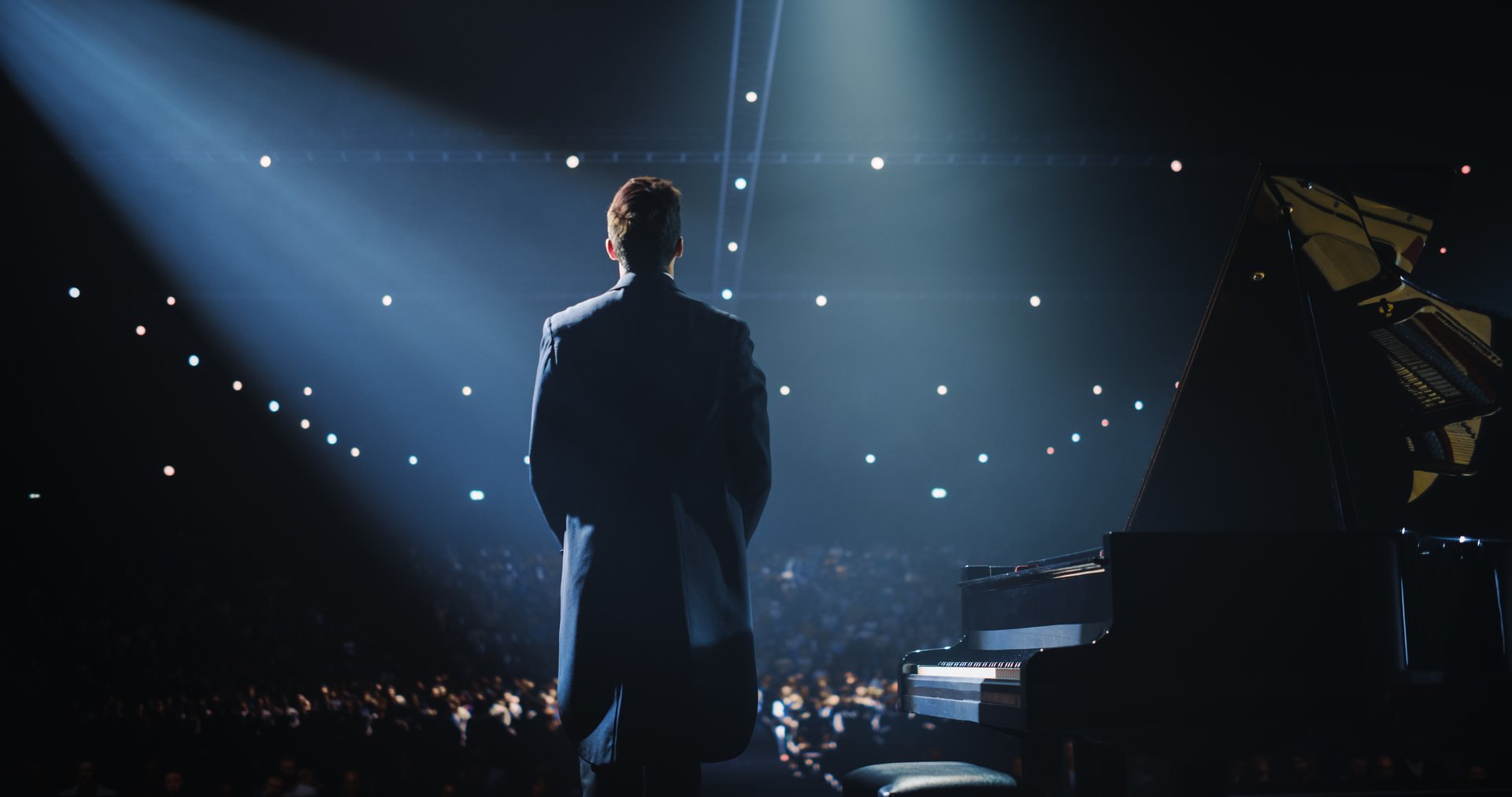 Caucasian Male Pianist Standing Beside the Grand Piano, Receiving Applause and Cheers From the Audience. Successful Musician Expressing His Gratitude for Their Enthusiastic Praise