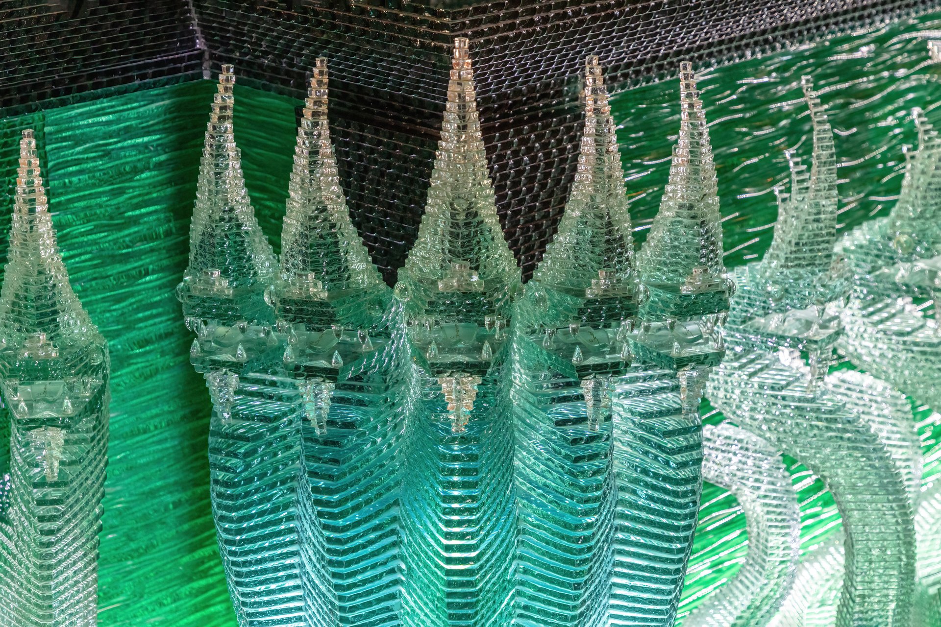 Glass serpent sculptures surrounding the emerald-green glass pagoda at the Buddhist temple of Wat Paknam Phasi Charoen in Bangkok, Thailand.