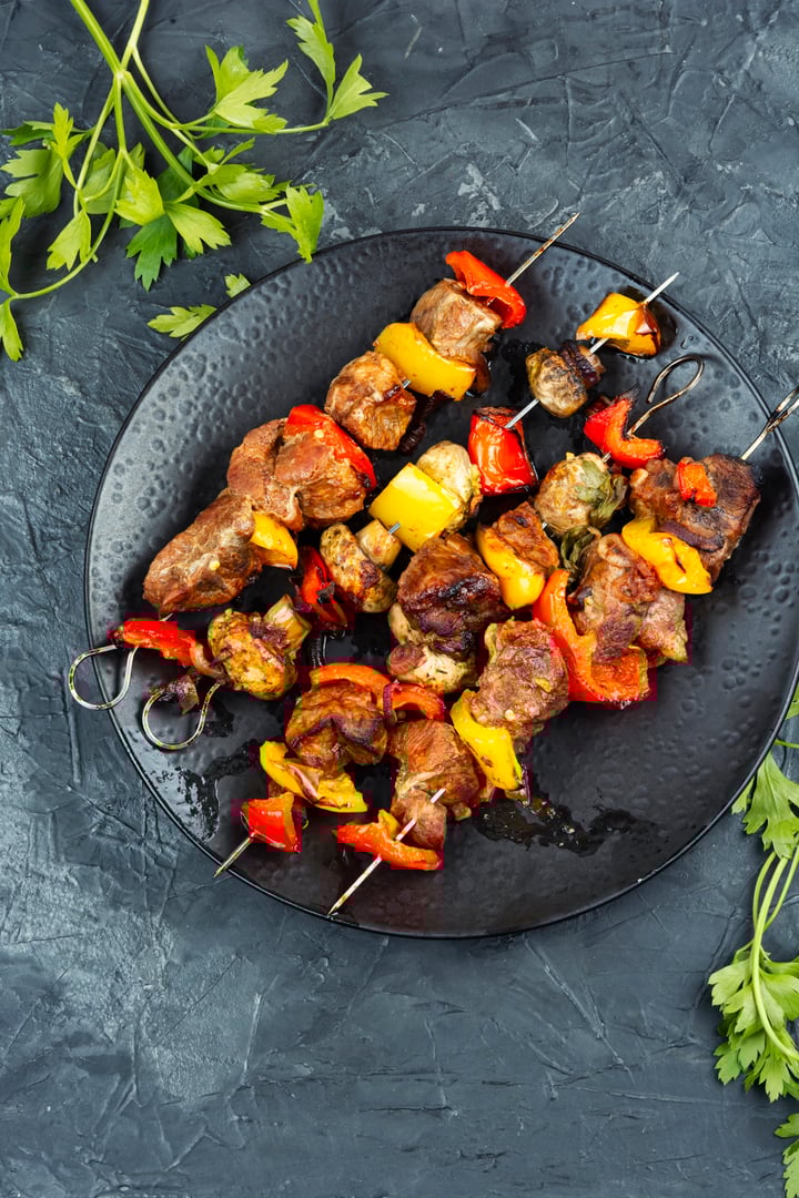 Meat skewers with grilled vegetables on a plate, kabobs on the BBQ
