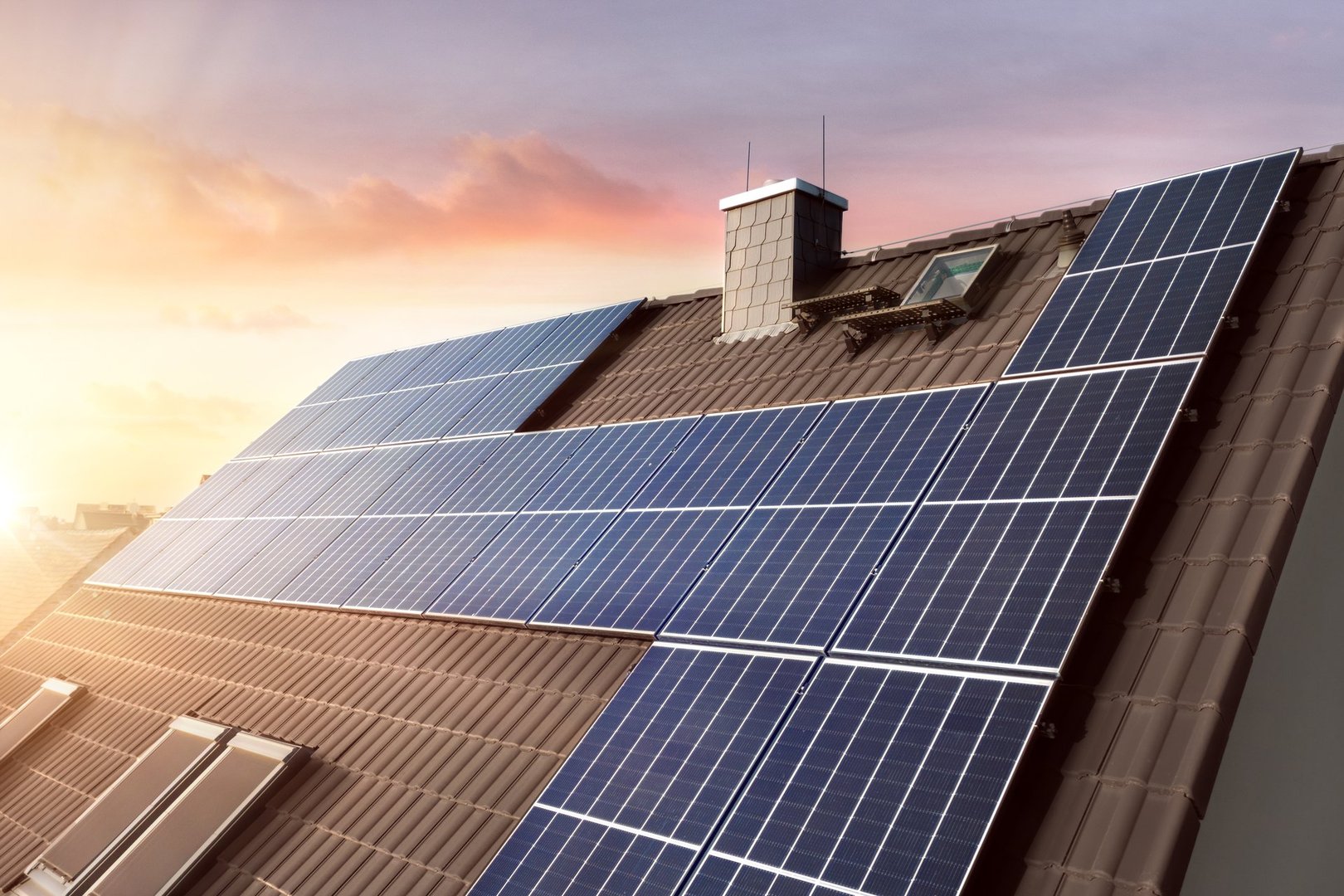 Rooftop of a sustainable German family home with solar panels at sunset.