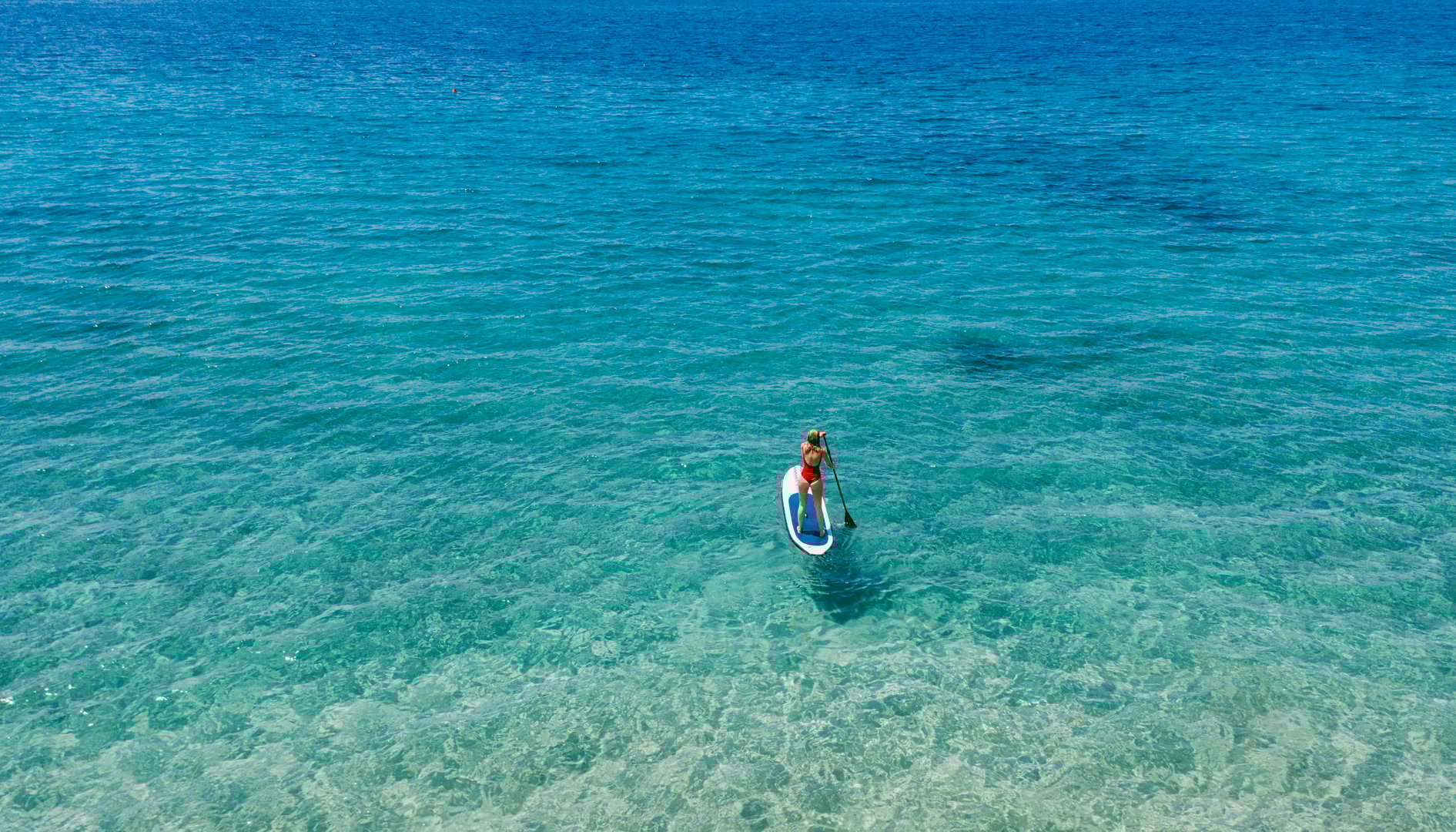Aerial view of woman riding paddleboard