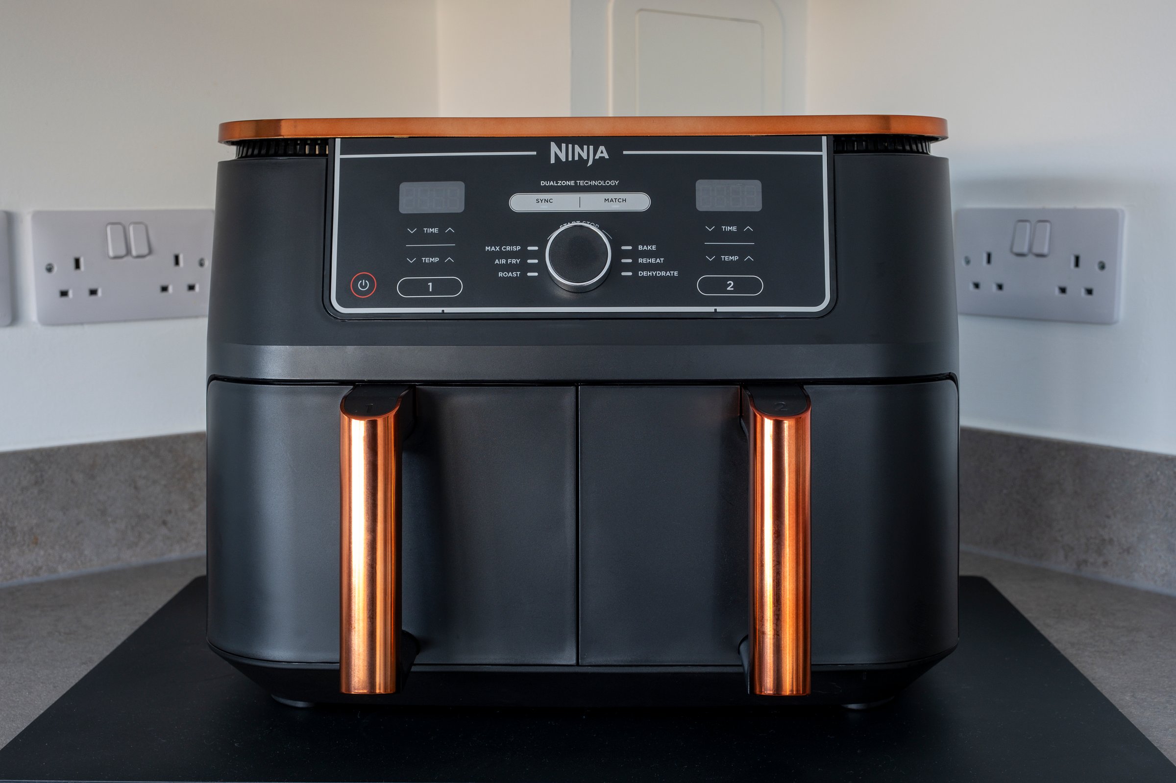 Irvine, Scotland, UK - October 27, 2024:  Ninja Brand Deluxe Black & Copper Foodi MAX Dual Zone Air Fryer with Smart Cook System AF451UKDBCP. The ecological alternative to conventional oven cooking and better for the environment.