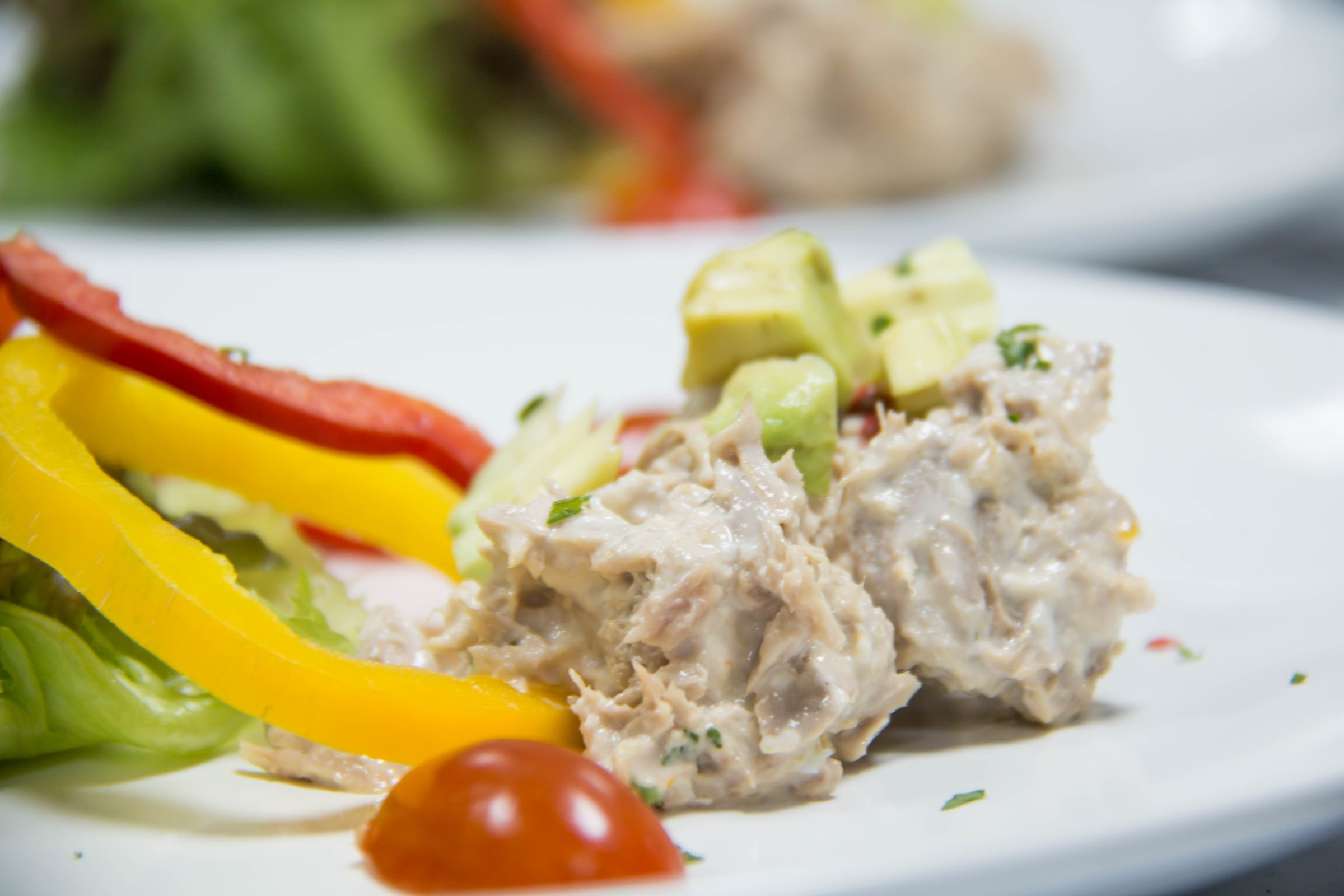 Tuna salad with tomatoes avoado pepper and greens vagetabel close up