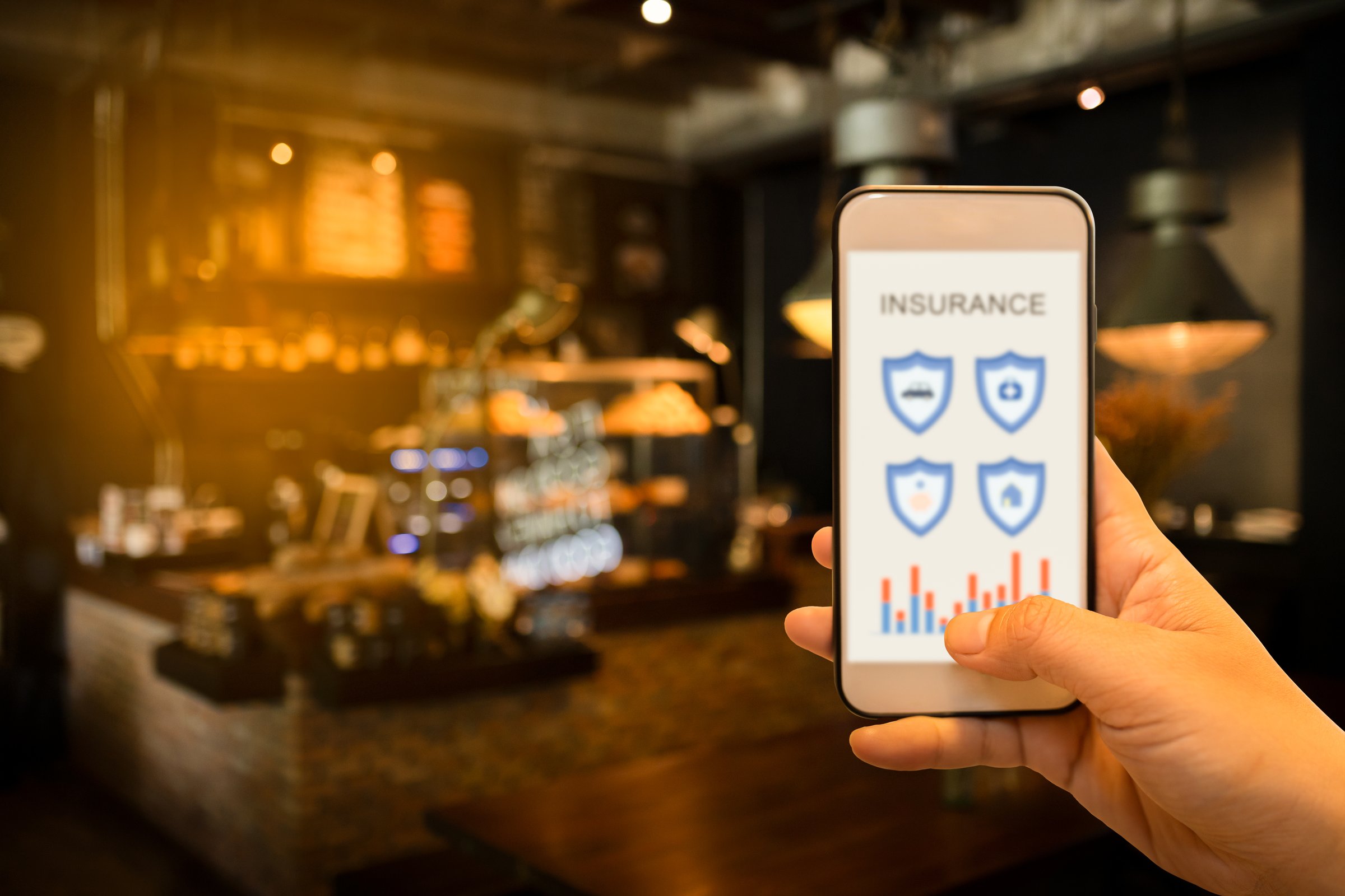 Hand holding smartphone to search for insurance online