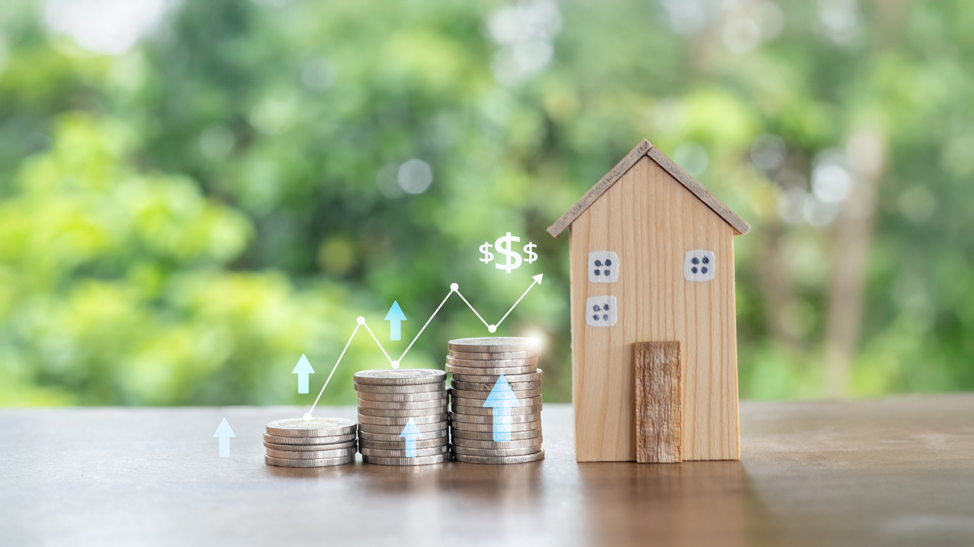 Stacks of coins with a growth chart and a wooden house model representing real estate investment, financial growth, savings, mortgage, and wealth accumulation for long-term financial success.