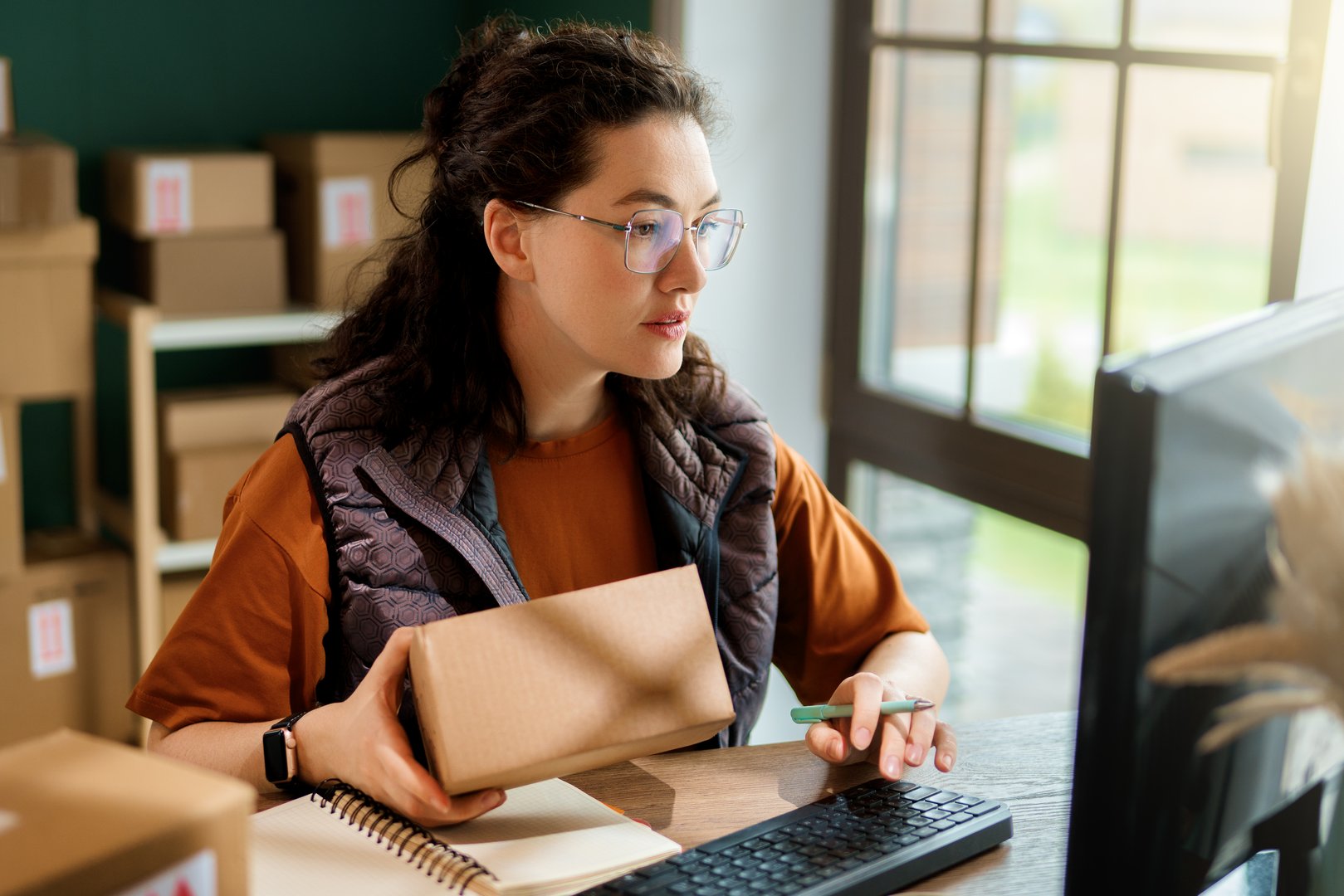 Female inventory manager checking stock. Woman working in a warehouse.
